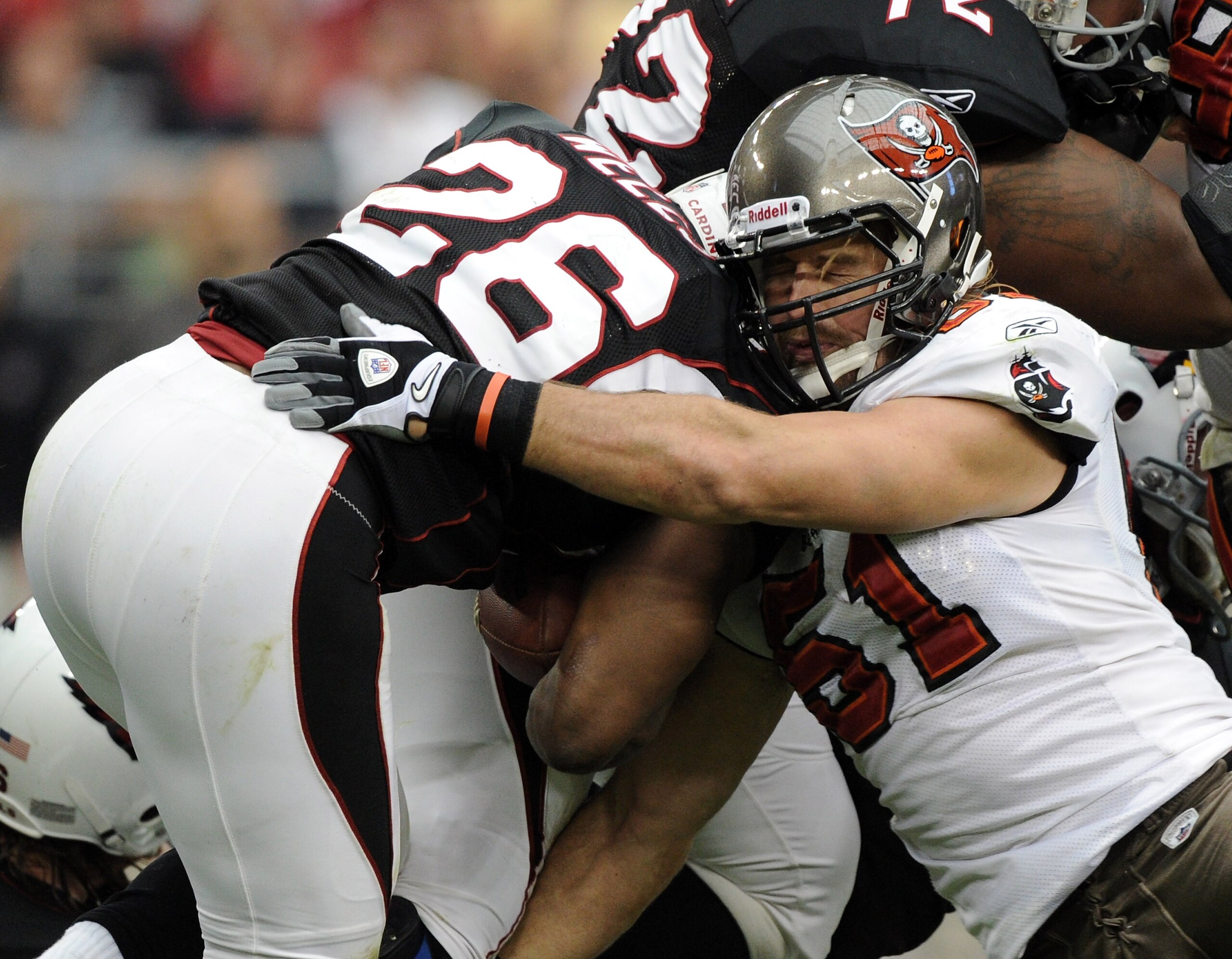 GLENDALE, AZ - OCTOBER 31:  Barrett Ruud #51 of the Tampa Bay Buccaneers tackles Beanie Wells #26 of the Arizona Cardinals at University of Phoenix Stadium on October 31, 2010 in Glendale, Arizona.  (Photo by Harry How/Getty Images)