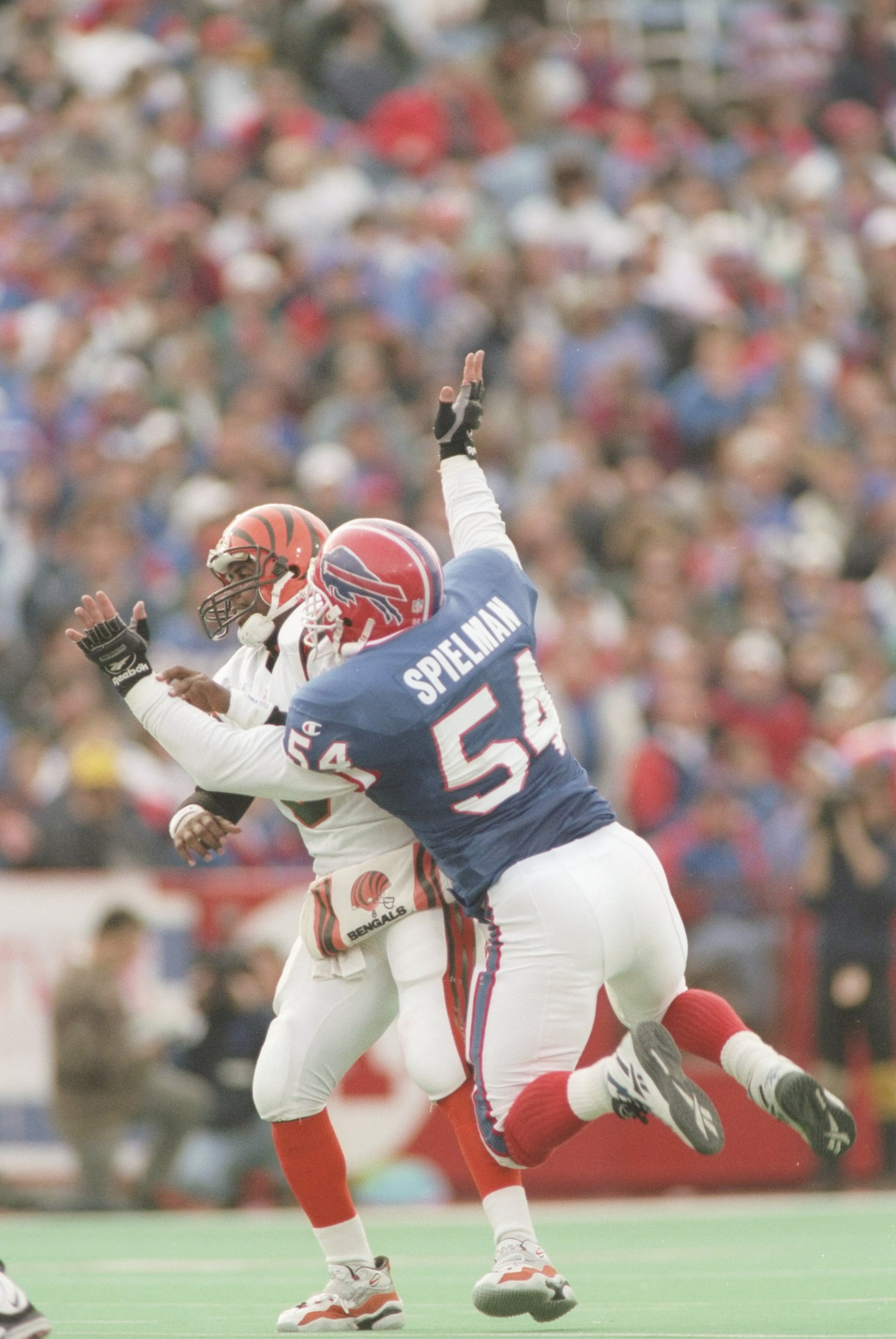 17 Nov 1996: Quarterback Jeff Blake of the Cincinnati Bengals is sacked by linebacker Chris Spielman of the Buffalo Bills during the Bengals 31-17 loss to the Buffalo Bills at Rich Stadium in Orchard Park, New York.