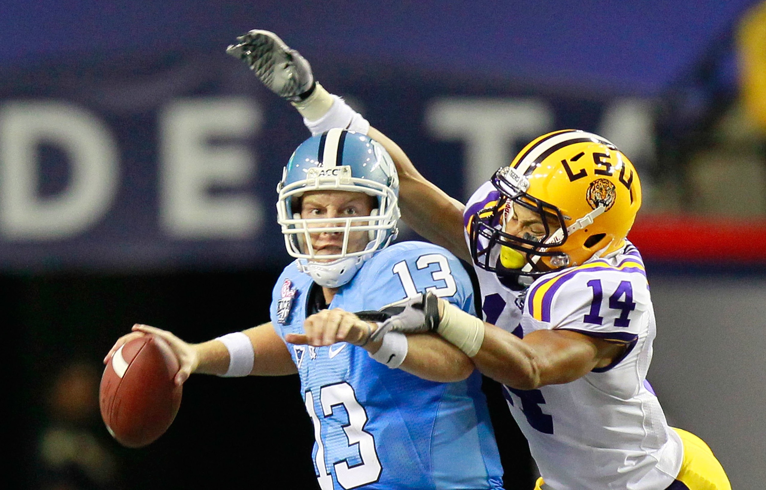 ATLANTA - SEPTEMBER 04:  Tyrann Mathieu #14 of the LSU Tigers forces a fumble by quarterback T.J. Yates #13 of the North Carolina Tar Heels during the Chick-fil-A Kickoff Game at Georgia Dome on September 4, 2010 in Atlanta, Georgia.  (Photo by Kevin C. C