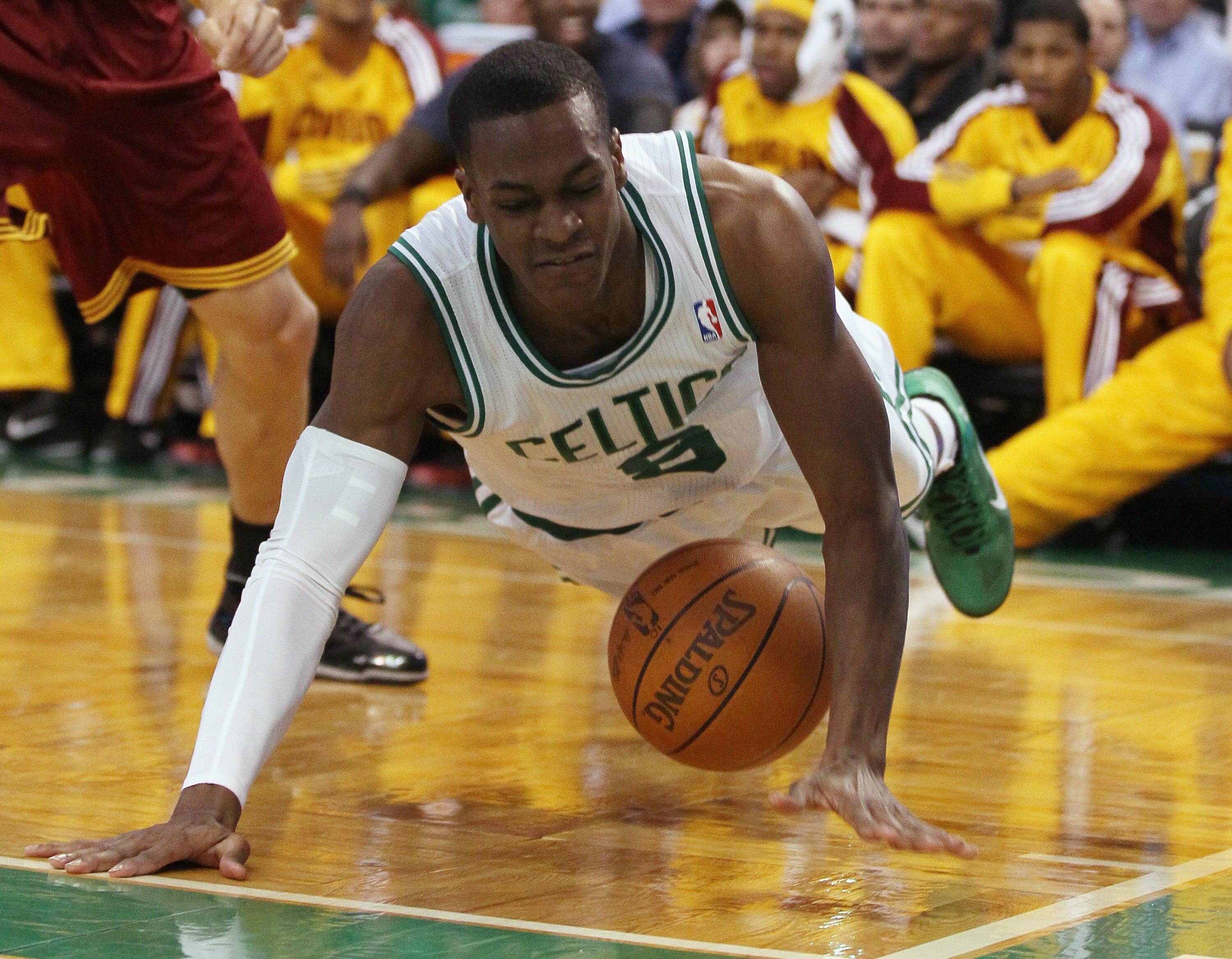 BOSTON, MA - JANUARY 25:  Rajon Rondo #9 of the Boston Celtics dives for the loose ball after he was fouled by Anthony Parker of the Cleveland Cavaliers on January 25, 2011 at the TD Garden in Boston, Massachusetts.   NOTE TO USER: User expressly acknowle