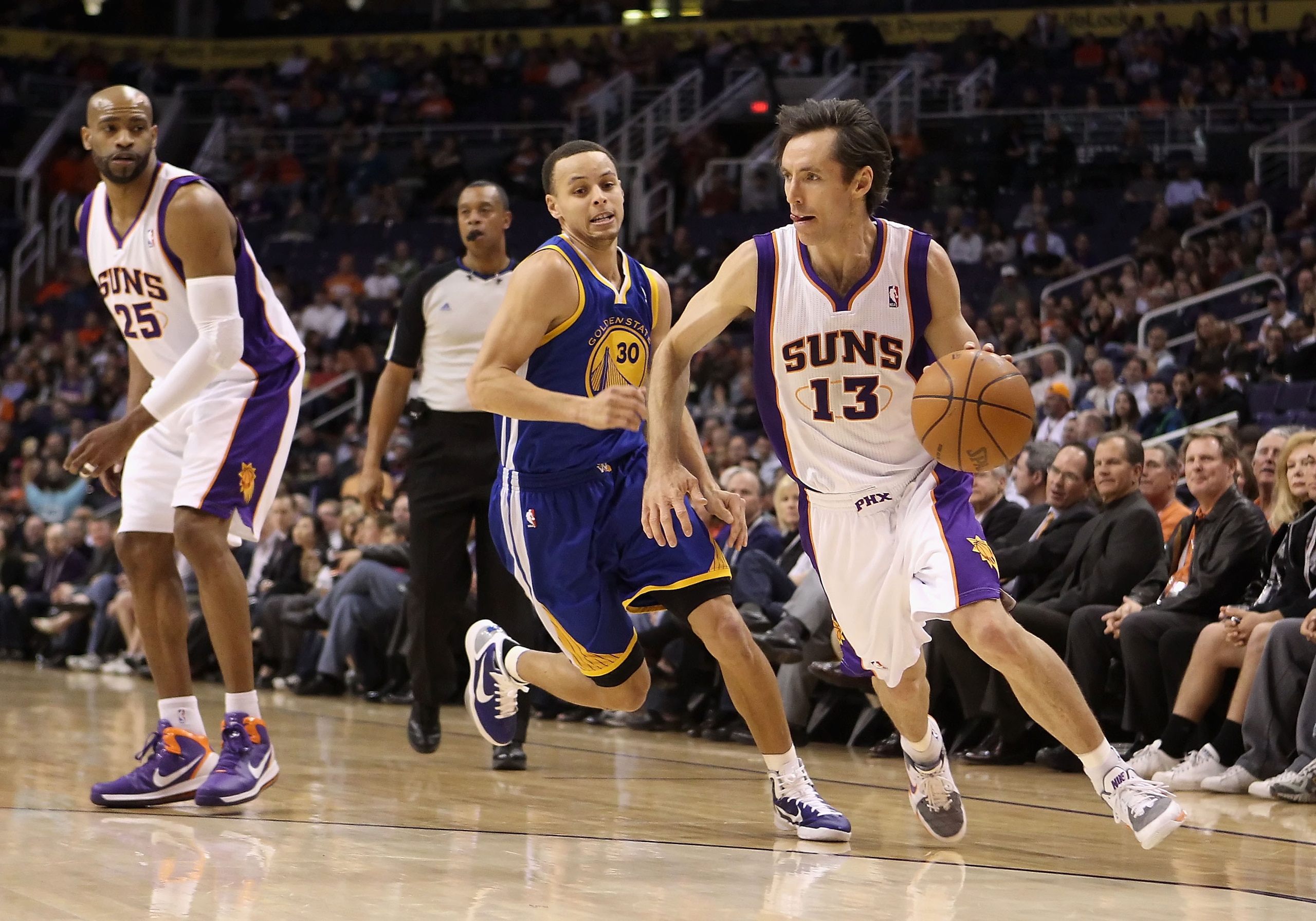 PHOENIX, AZ - FEBRUARY 10:  Steve Nash #13 of the Phoenix Suns drives the ball during the NBA game against the Golden State Warriors at US Airways Center on February 10, 2011 in Phoenix, Arizona.  The Suns defeated the Warriors 112-88.  NOTE TO USER: User
