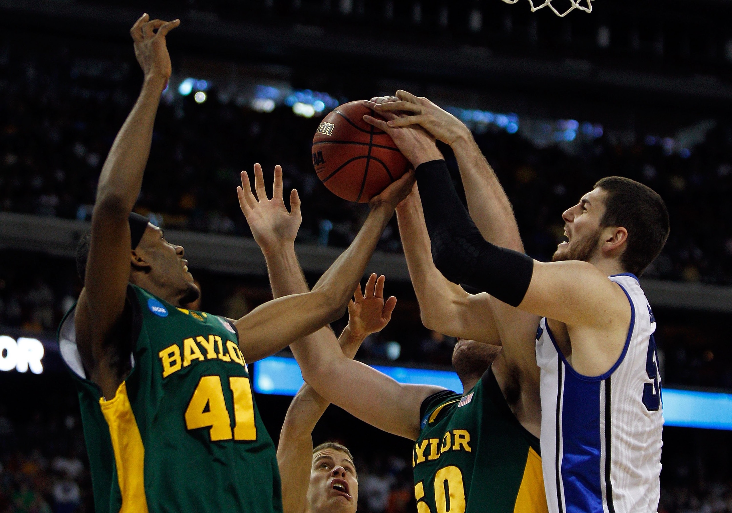 HOUSTON - MARCH 28: Brian Zoubek #55 of the Duke Blue Devils grabs a rebound from Anthony Jones #41 and Josh Lomers #50 of the Baylor Bears during the south regional final of the 2010 NCAA men's basketball tournament at Reliant Stadium on March 28, 2010 i HOUSTON - MARCH 28: Brian Zoubek #55 of the Duke Blue Devils grabs a rebound from Anthony Jones #41 and Josh Lomers #50 of the Baylor Bears during the south regional final of the 2010 NCAA men's basketball tournament at Reliant Stadium on March 28, 2010 i