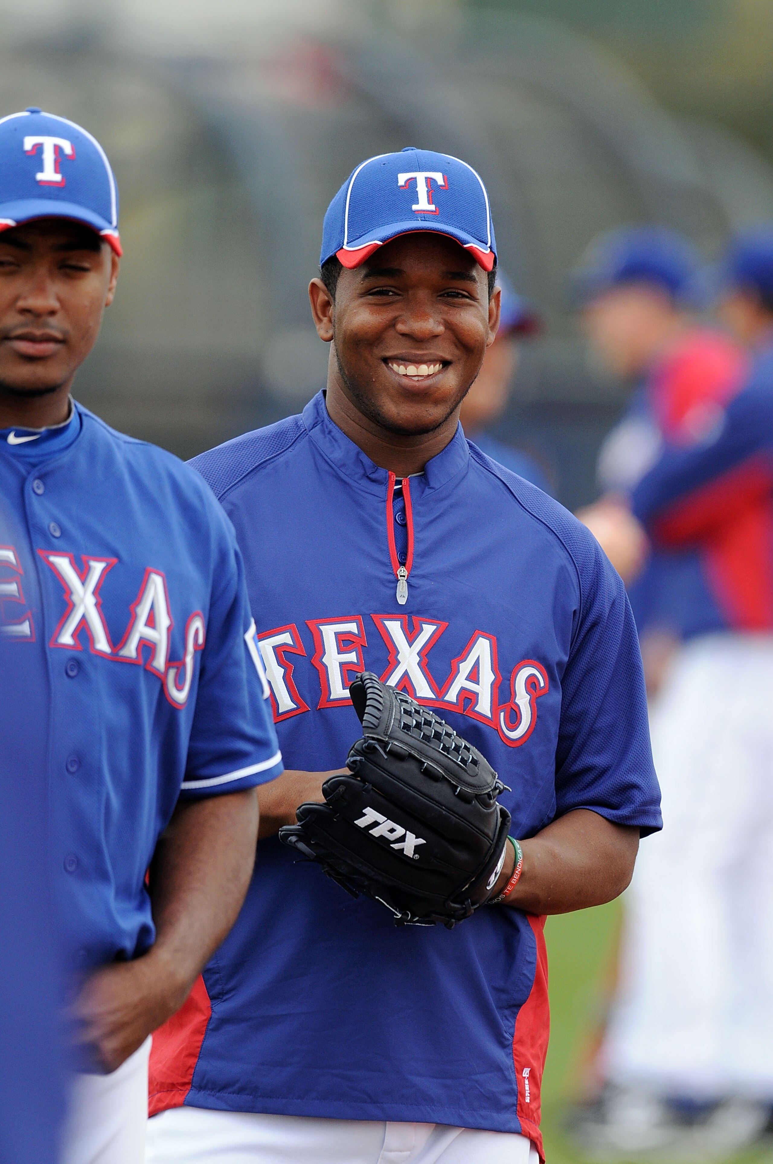 SURPRISE, AZ - FEBRUARY 18:  Neftali Feliz #30 of the Texas Rangers warms up prior to spring workouts at Surprise Stadium on February 18, 2011 in Surprise, Arizona.  (Photo by Norm Hall/Getty Images)