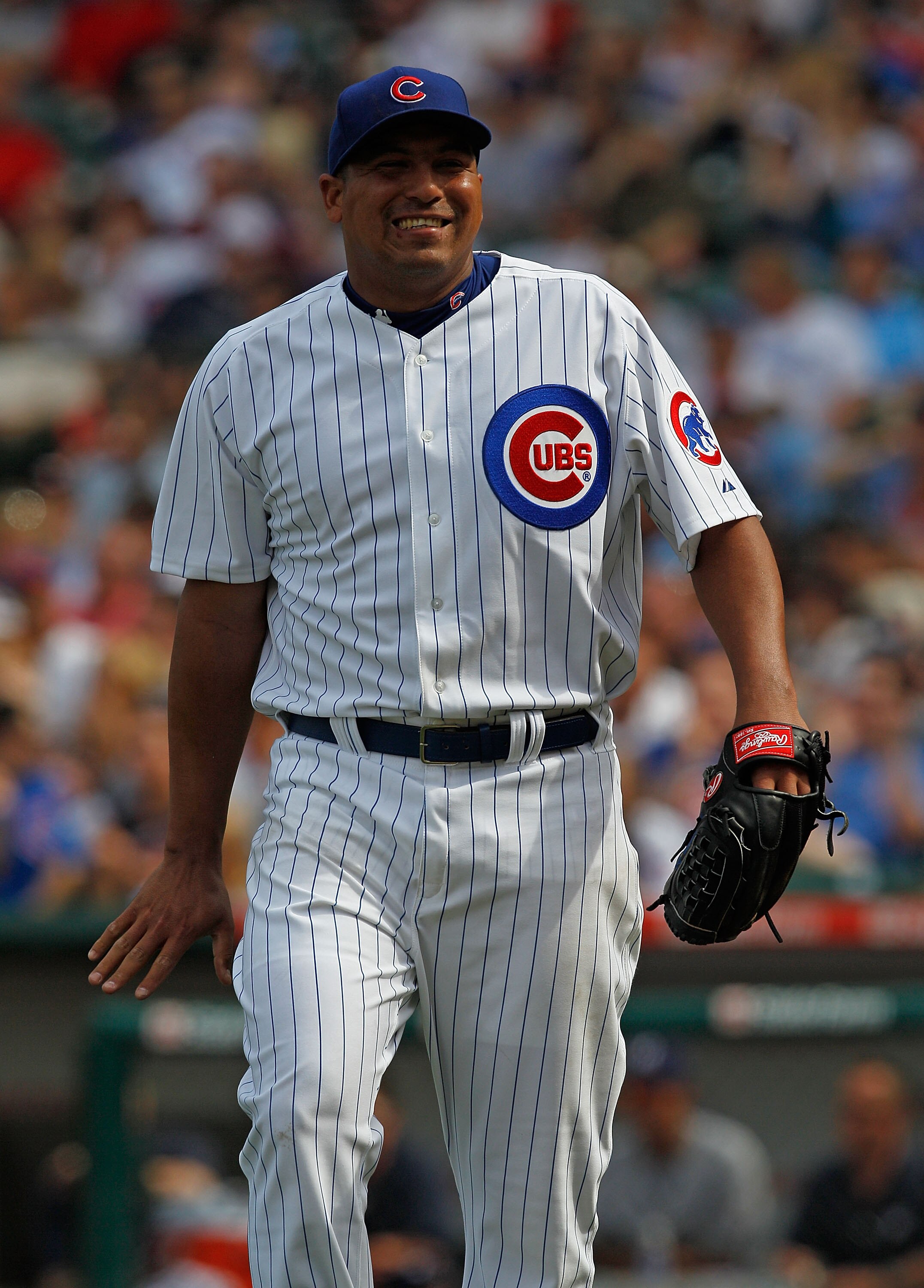 CHICAGO - APRIL 15: Starting pitcher Carlos Zambrano of the Chicago Cubs, wearing a number 42 jersey in honor of Jackie Robinson, reacts after an outfield catch by teammate Tyler Colvin against the Milwaukee Brewers at Wrigley Field on April 15, 2010 in C