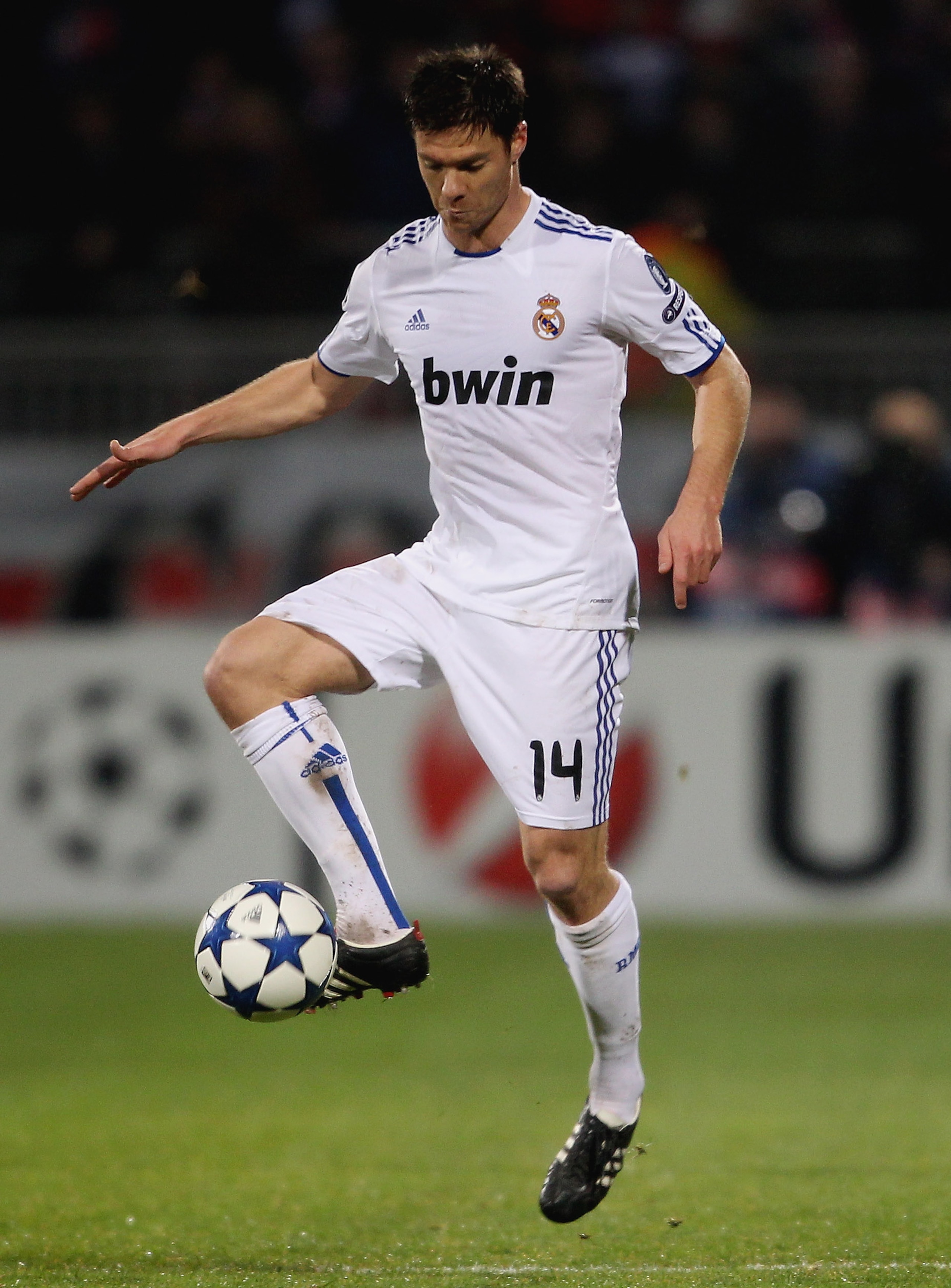 LYON, FRANCE - FEBRUARY 22:  Xabi Alonso of Real Madrid in action with Cesar Delgado during the Champions League match between Lyon and Real Madrid at Stade Gerland on February 22, 2011 in Lyon, France.  (Photo by Scott Heavey/Getty Images)