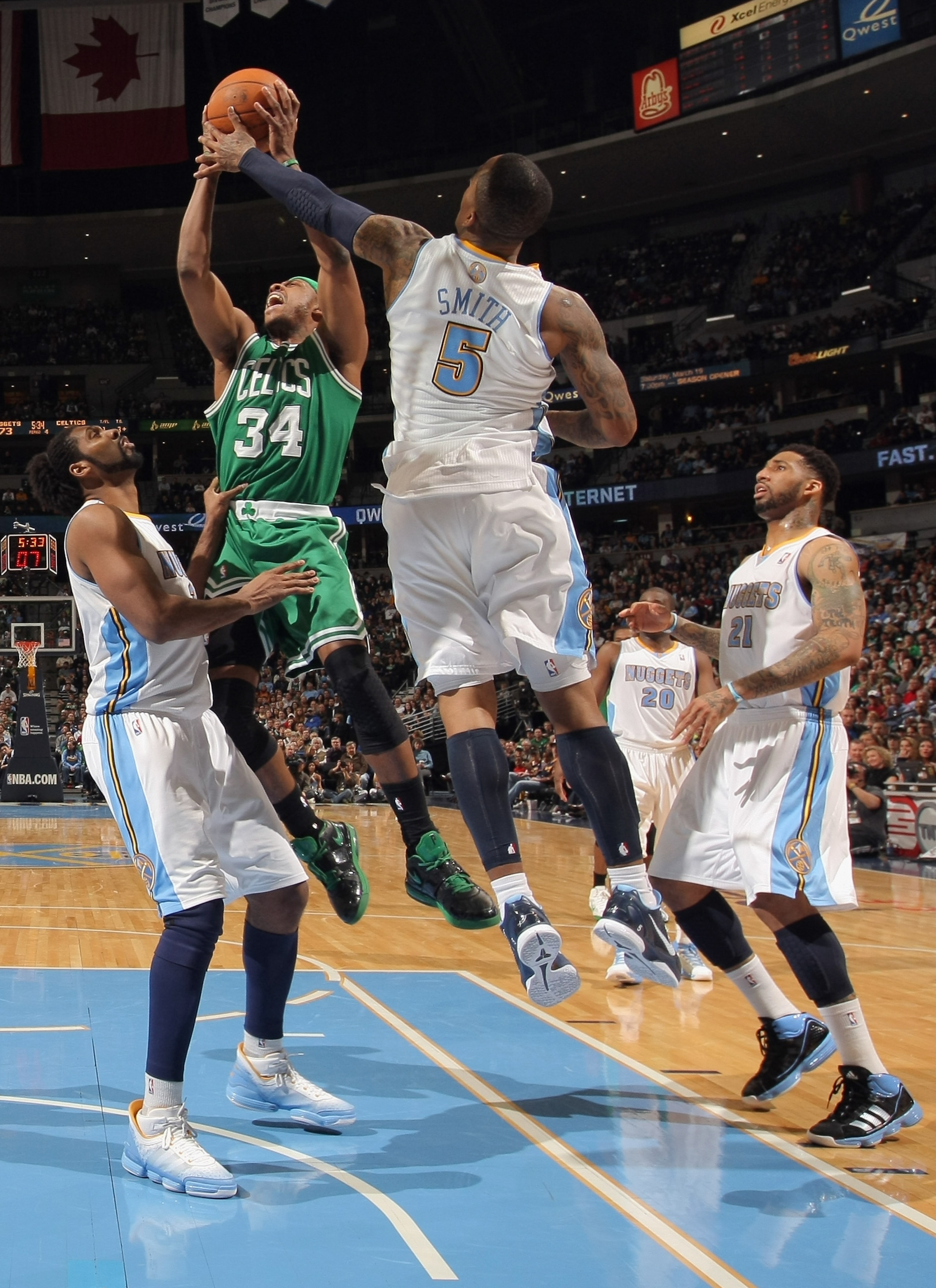 DENVER, CO - FEBRUARY 24:  Paul Pierce #34 of the Boston Celtics takes a shot and is fouled by J.R. Smith #5 of the Denver Nuggets as Nene #31 and Wilson Chandler #21 follow the play during NBA action at the Pepsi Center on February 24, 2011 in Denver, Co