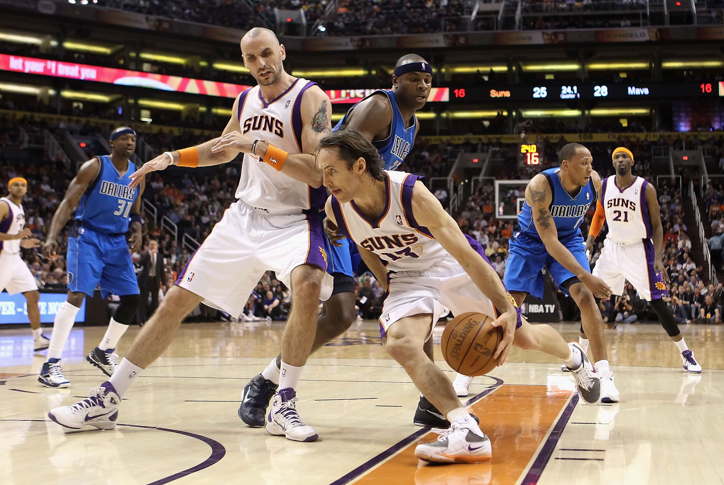PHOENIX, AZ - FEBRUARY 17:  Steve Nash #13 of the Phoenix Suns drives the ball past Marcin Gortat #4 and Brendan Haywood #33 of the Dallas Mavericks during the NBA game at US Airways Center on February 17, 2011 in Phoenix, Arizona.  NOTE TO USER: User exp