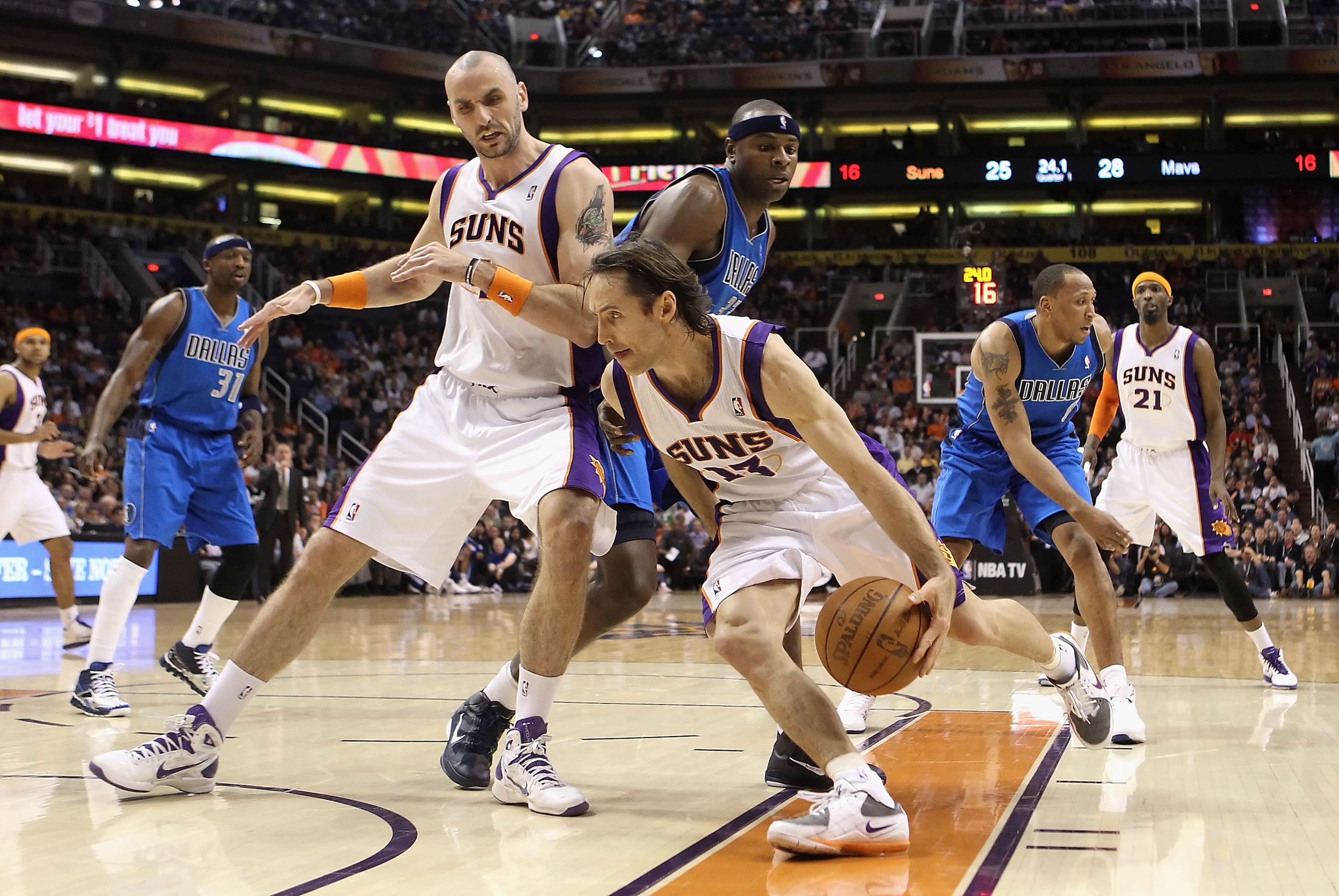 PHOENIX, AZ - FEBRUARY 17:  Steve Nash #13 of the Phoenix Suns drives the ball past Marcin Gortat #4 and Brendan Haywood #33 of the Dallas Mavericks during the NBA game at US Airways Center on February 17, 2011 in Phoenix, Arizona.  NOTE TO USER: User exp