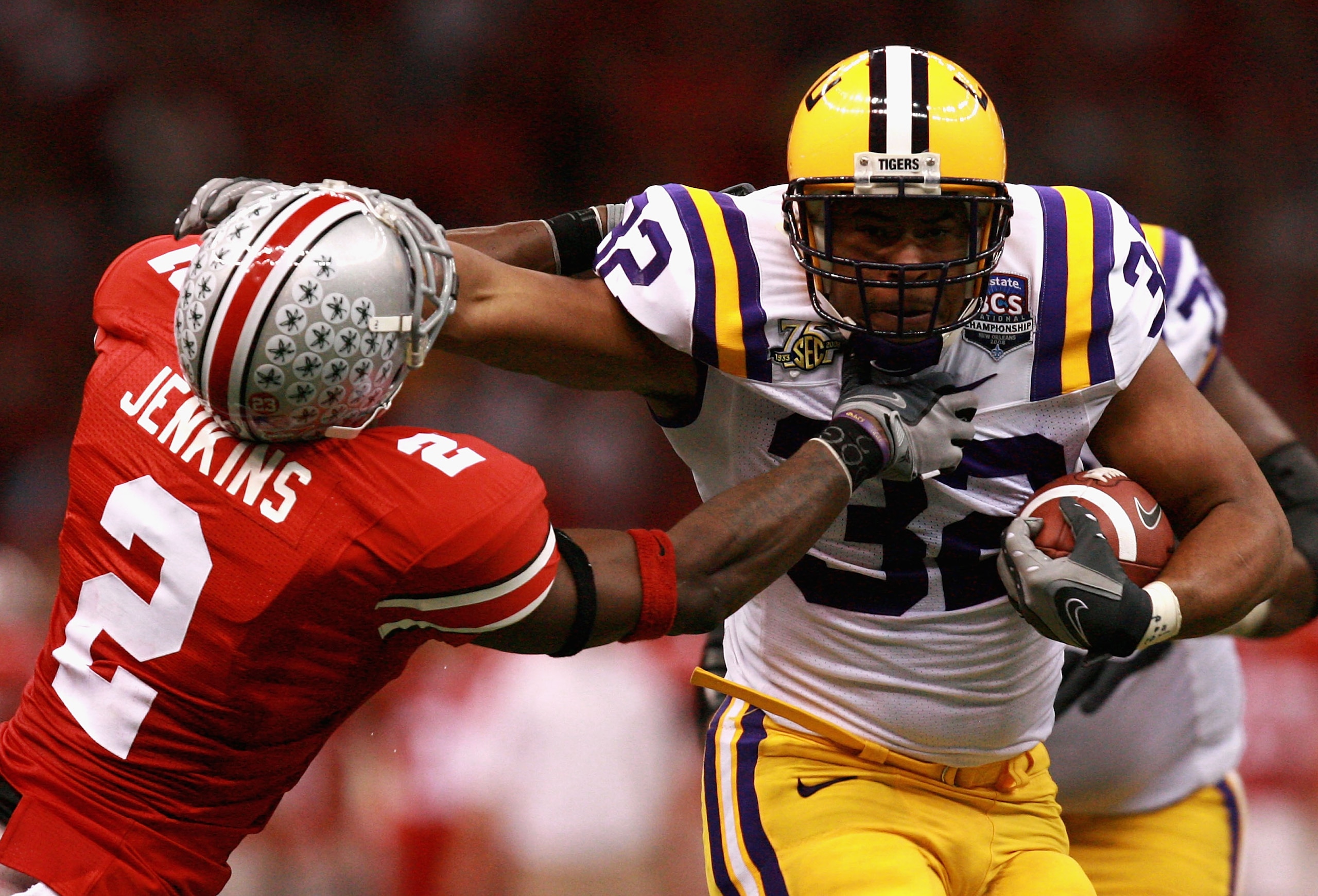 NEW ORLEANS - JANUARY 07:  Charles Scott #32 of the Louisiana State University Tigers stiffarms Malcolm Jenkins #2 of the Ohio State Buckeys during the AllState BCS National Championship on January 7, 2008 at the Louisiana Superdome in New Orleans, Louisi