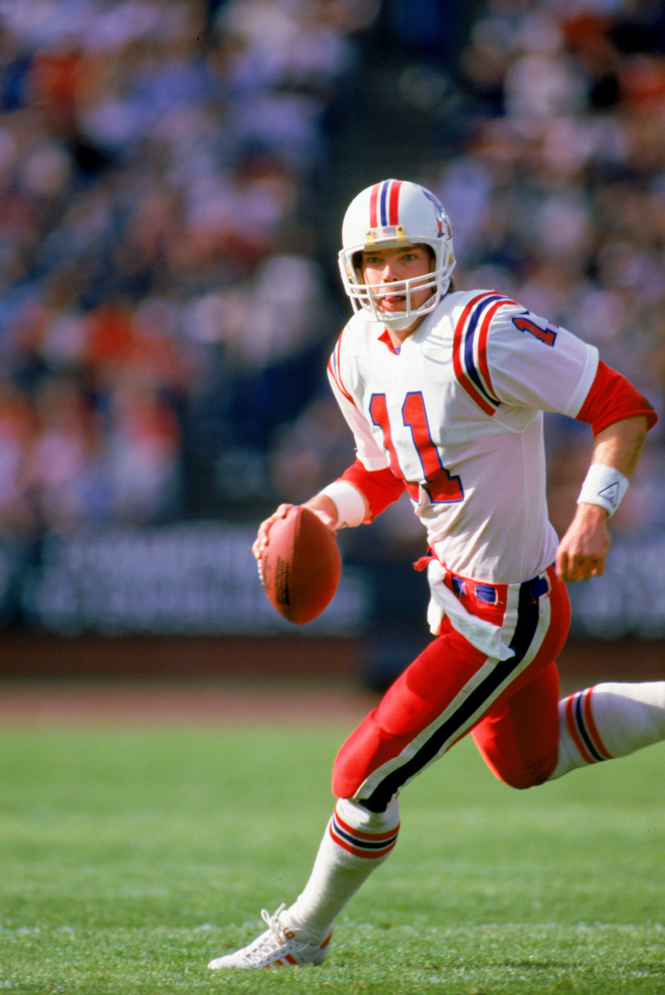 LOS ANGELES - JANUARY 5:  Quarterback Tony Eason #11 of the New England Patriots rolls out during the 1985 AFC Division Playoff against the Los Angeles Raiders at the LA Memorial Coliseum on January 5, 1986 in Los Angeles, California.  The Pats defeated t