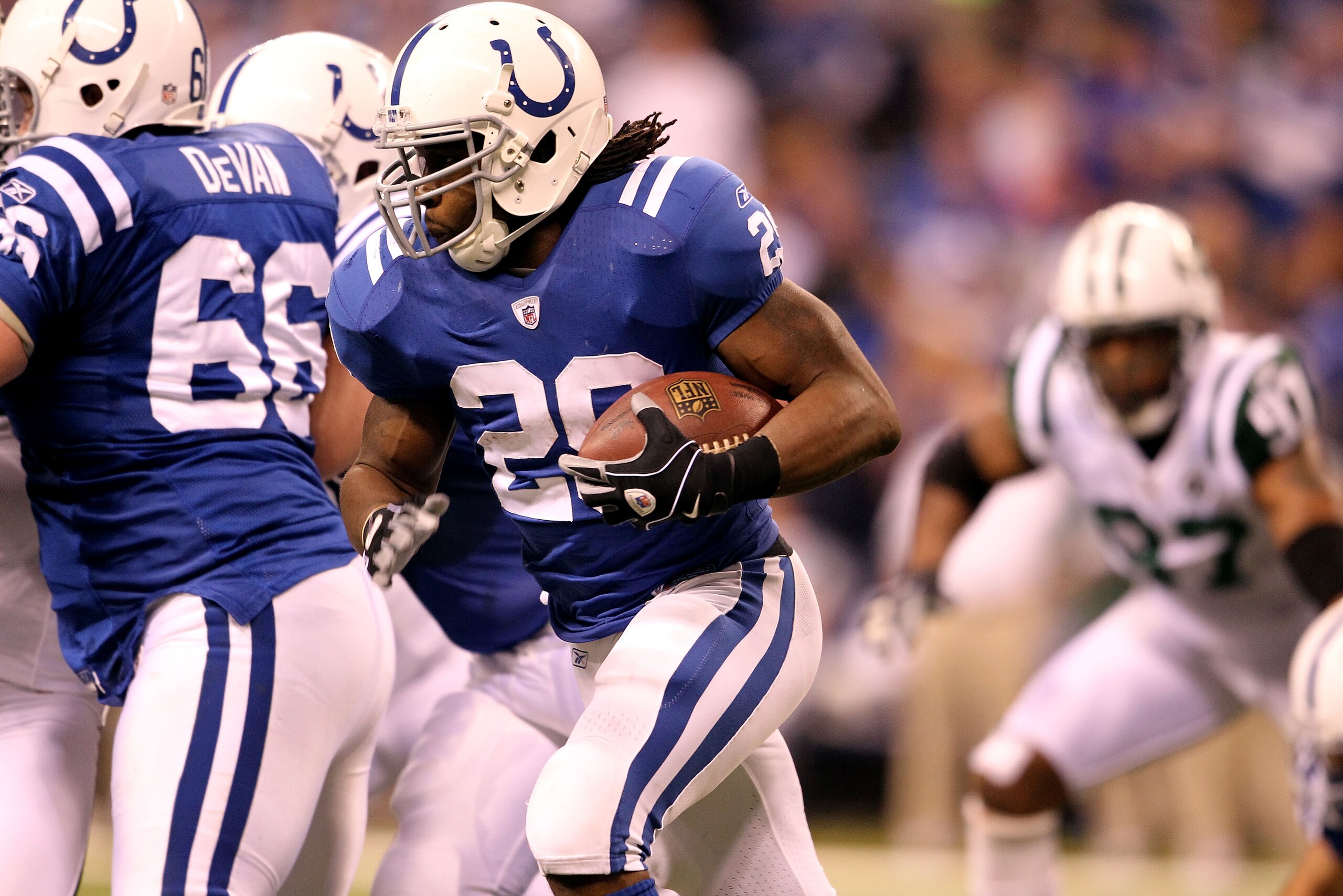 INDIANAPOLIS, IN - JANUARY 08:  Joseph Addai #29 of the Indianapolis Colts runs the ball against the New York Jets during their 2011 AFC wild card playoff game at Lucas Oil Stadium on January 8, 2011 in Indianapolis, Indiana. The Jets won 17-16. (Photo by