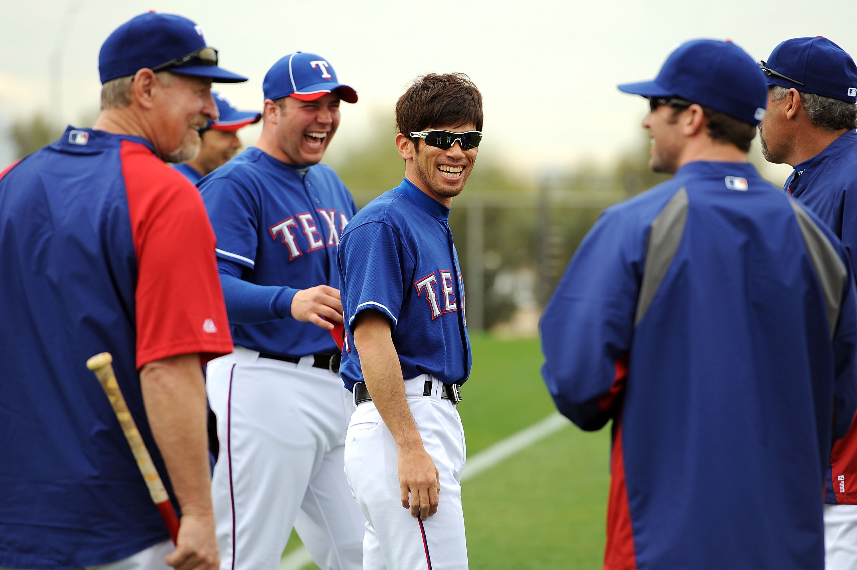 SURPRISE, AZ - FEBRUARY 18:  Yoshinori Tateyama #22 of the Texas Rangers laughs with some of his teammates prior to pratice at Surprise Stadium on February 18, 2011 in Surprise, Arizona.  (Photo by Norm Hall/Getty Images)