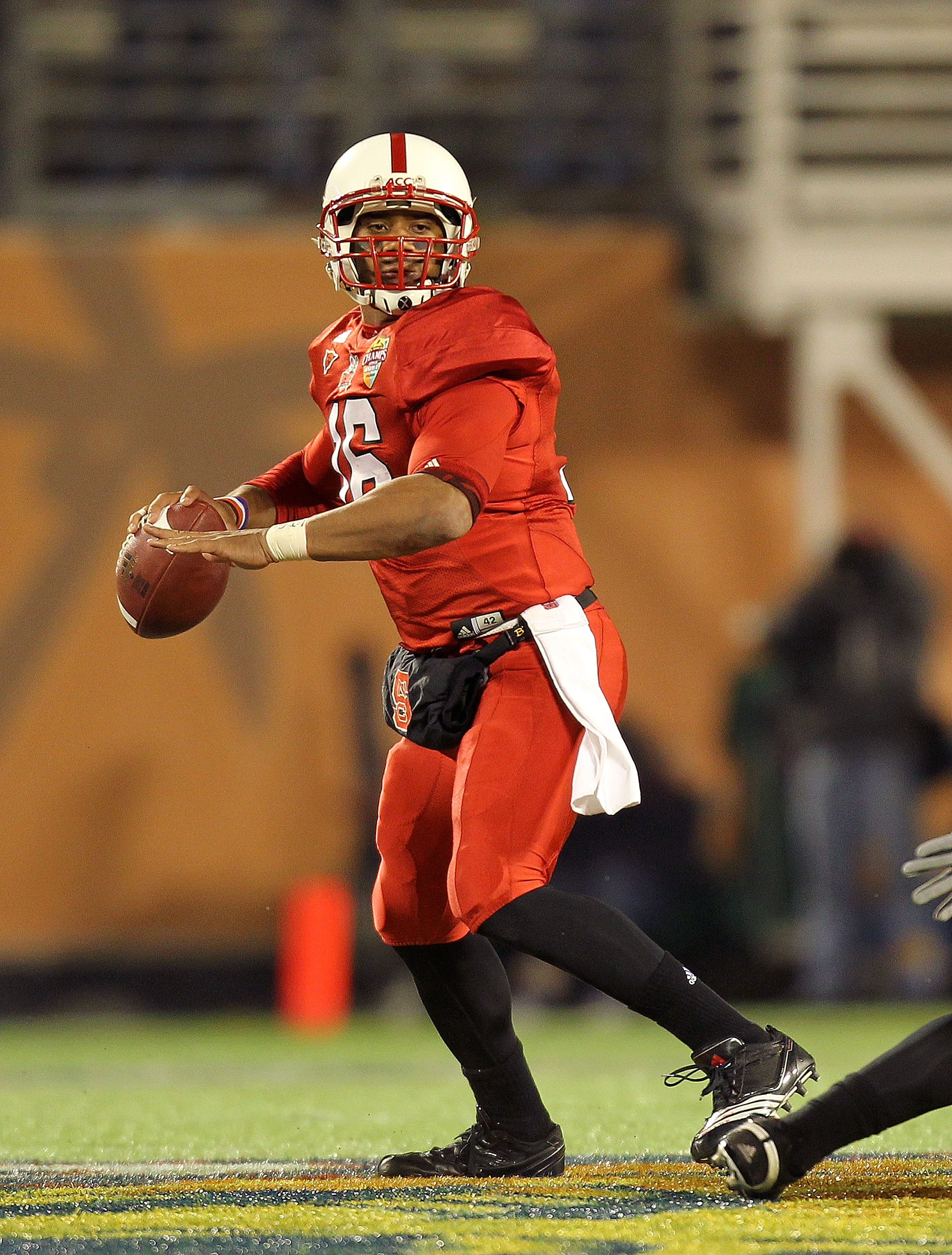 ORLANDO, FL - DECEMBER 28: Russell Wilson #16 of the North Carolina State Wolfpack passes the ball during the Champs Sports Bowl against the West Virginia Mountineers at Florida Citrus Bowl Stadium on December 28, 2010 in Orlando, Florida. (Photo by Mik