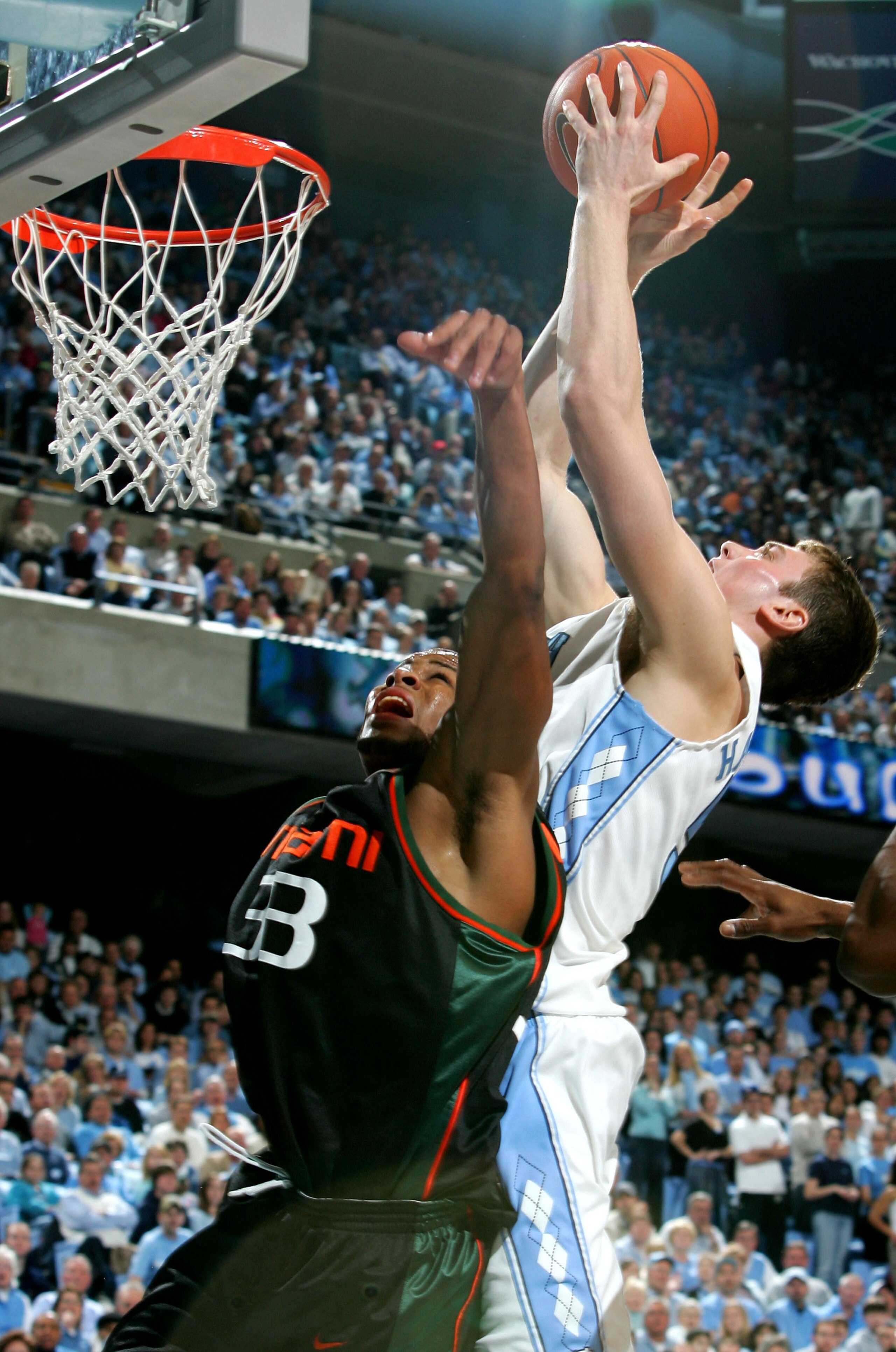 CHAPEL HILL, NC - JANUARY 31:  Jack McClinton #33 of the Miami Hurricanes jumps for a loose ball with Tyler Hansbrough #50 of the University of North Carolina Tar Heels at the Dean E. Smith Center on January 31, 2007 in Chapel Hill, North Carolina.  (Phot