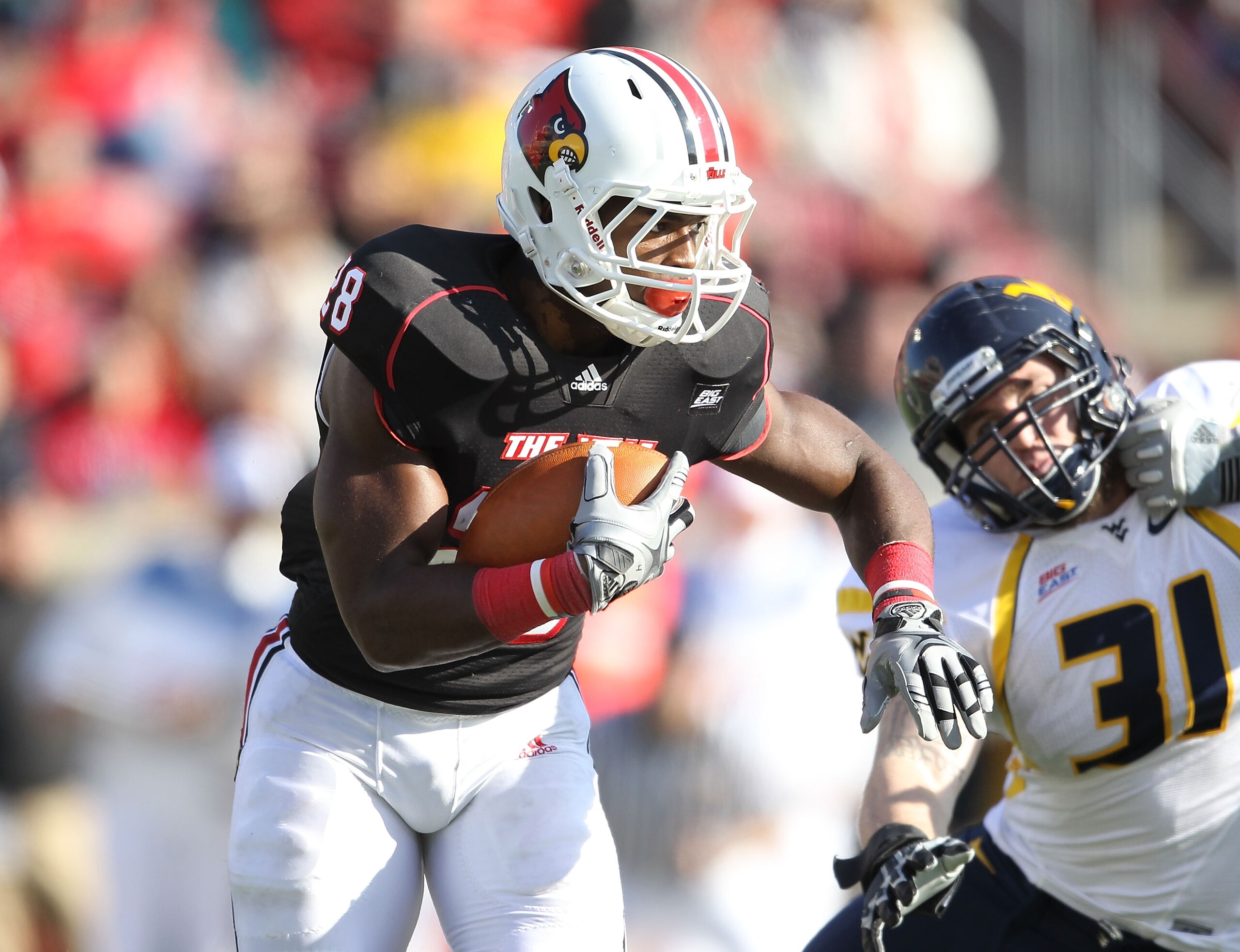LOUISVILLE, KY - NOVEMBER 20:  Jeremy Wright #28 of the Louisville Cardinals runs with the ball during the Big East Conference game against the West Virginia Mountaineers at Papa John's Cardinal Stadium on November 20, 2010 in Louisville, Kentucky.  (Phot
