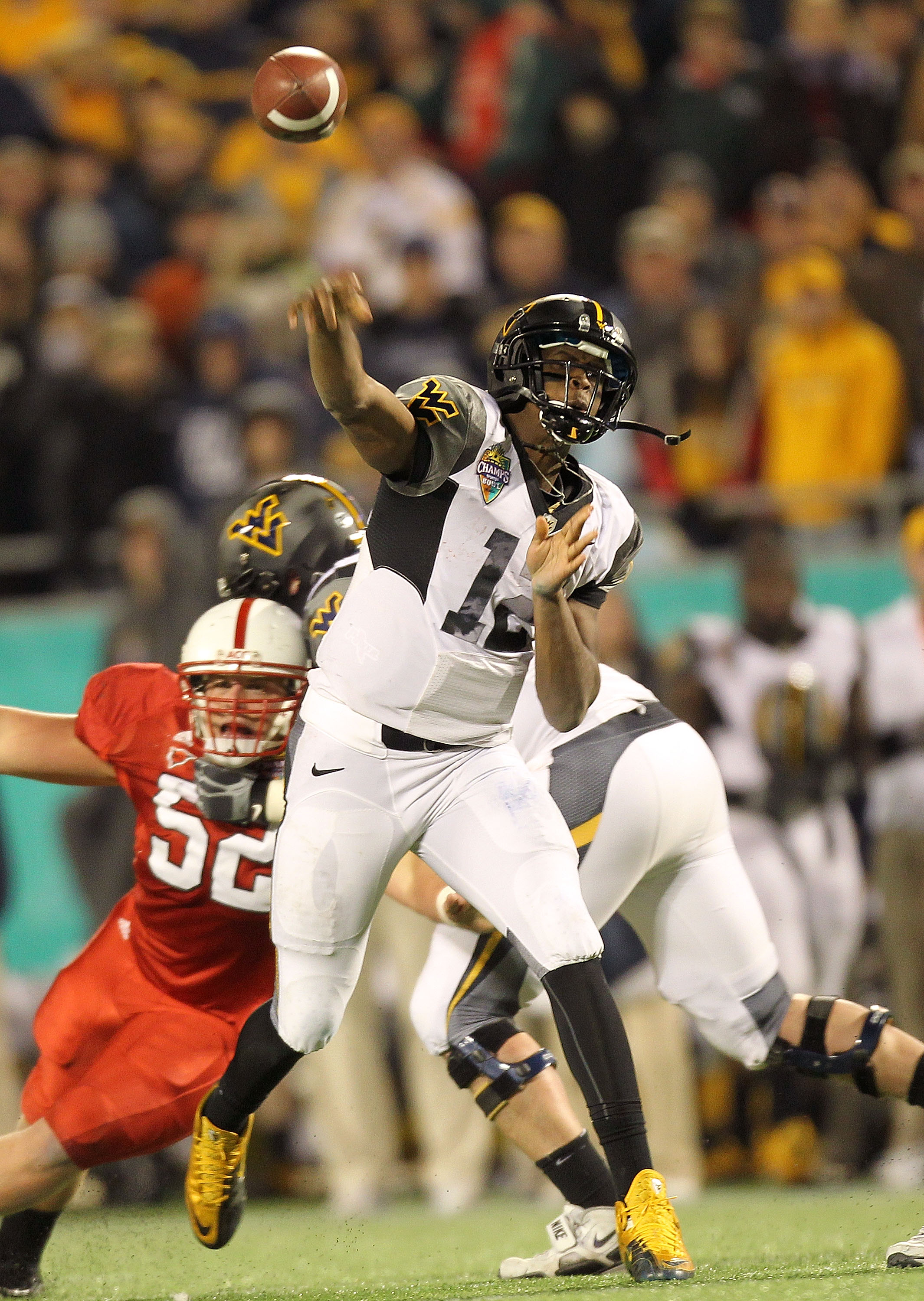 ORLANDO, FL - DECEMBER 28: Geno Smith #12 of the West Virginia Mountineers passes the ball during the Champs Sports Bowl against the North Carolina State Wolfpack at Florida Citrus Bowl Stadium on December 28, 2010 in Orlando, Florida. (Photo by Mike Eh