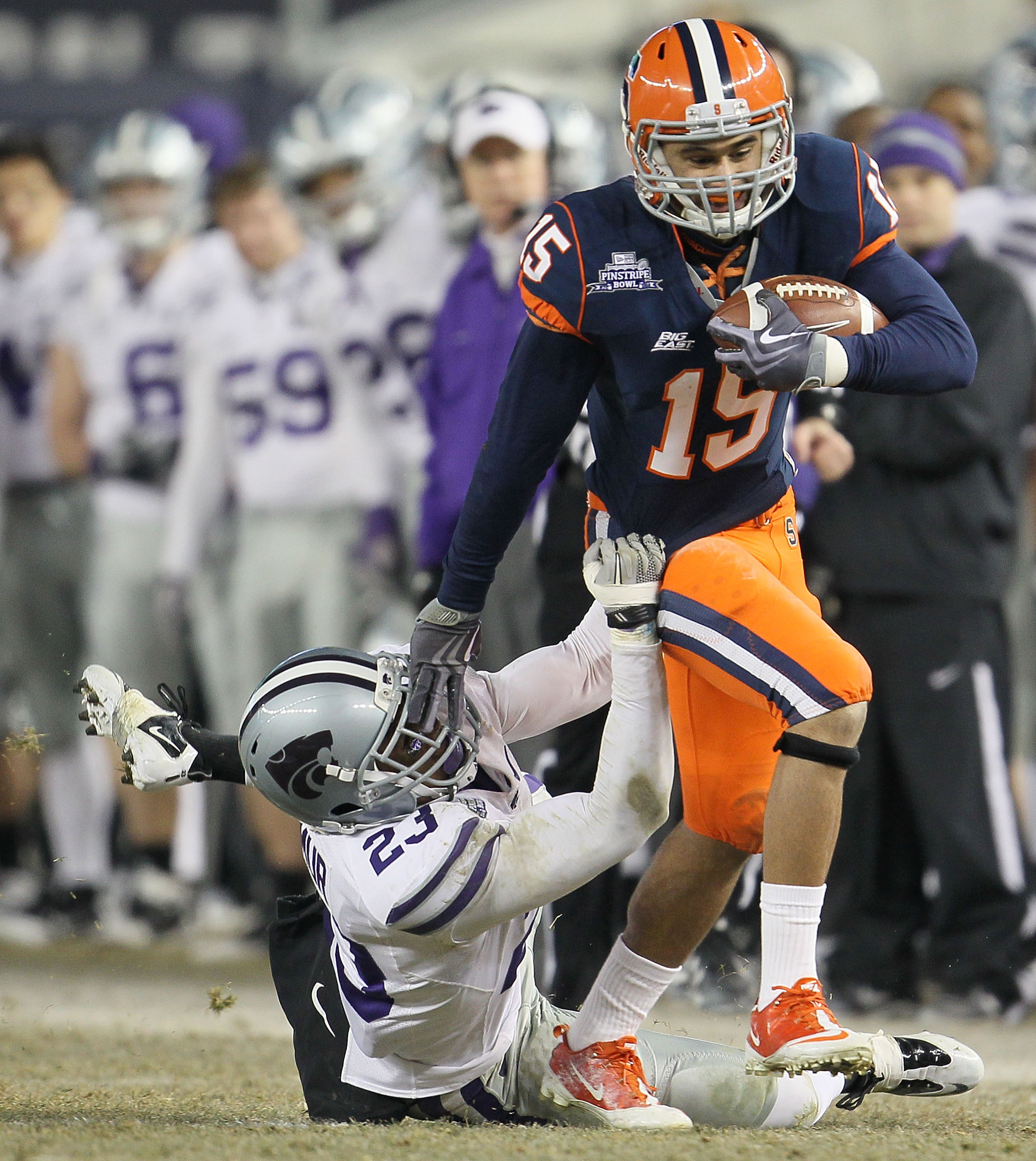 NEW YORK, NY - DECEMBER 30: Alec Lemon #15 of the Syracuse Orange is tackled by Emmanuel Lamur #23 of the Kansas State Wildcats during the New Era Pinstripe Bowl at Yankee Stadium on December 30, 2010 in New York, New York. (Photo by Chris McGrath/Getty