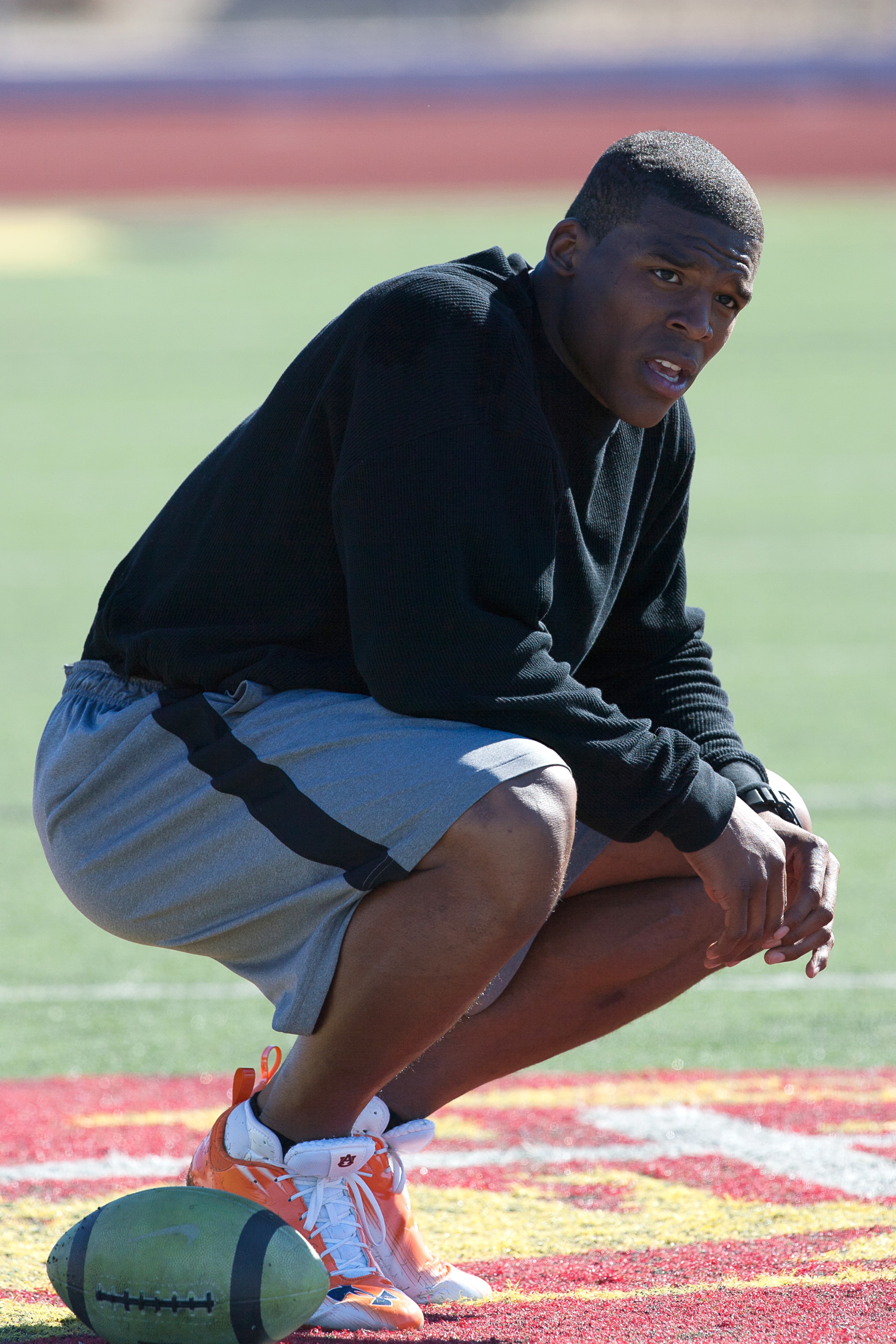 SAN DIEGO, CA - FEBRUARY 10: 2010 Heisman Trophy winning quarterback Cam Newton of Auburn pauses during his workout routine for the media at Cathedral High School's sports stadium on February 10, 2011 in San Diego, California. (Photo by Kent Horner/ Getty