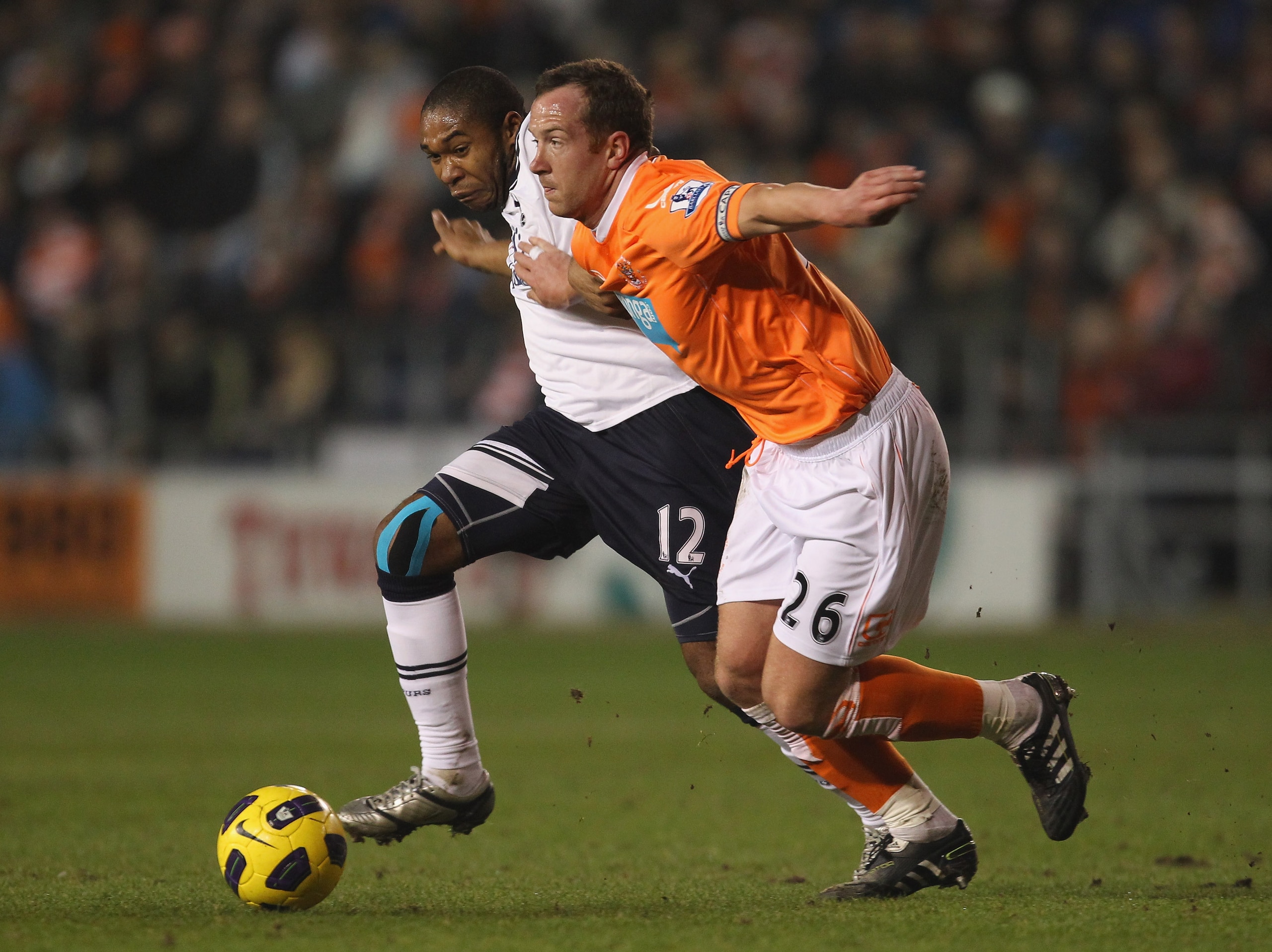 BLACKPOOL, ENGLAND - FEBRUARY 22:  Charlie Adam of Blackpool holds off a challenge from Wilson Palacios of Tottenham Hotspur during the Barclays Premier League match between Blackpool and Tottenham Hotspur at Bloomfield Road on February 22, 2011 in Blackp