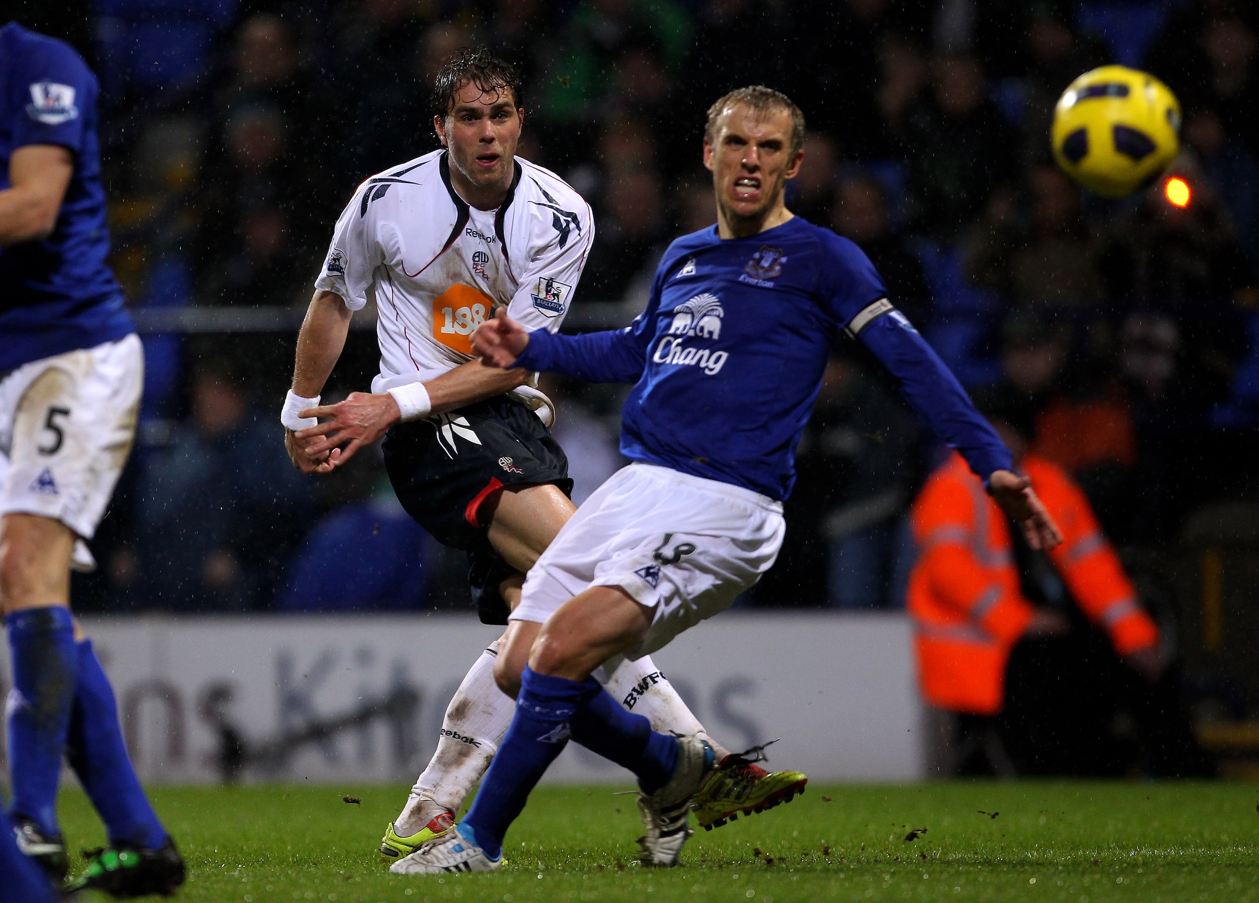 BOLTON, ENGLAND - FEBRUARY 13:  Johan Elmander of Bolton Wanderers shoots past Phil Neville of Everton during the Barclays Premier League match between Bolton Wanderers and Everton at the Reebok Stadium on February 13, 2011 in Bolton, England.  (Photo by 