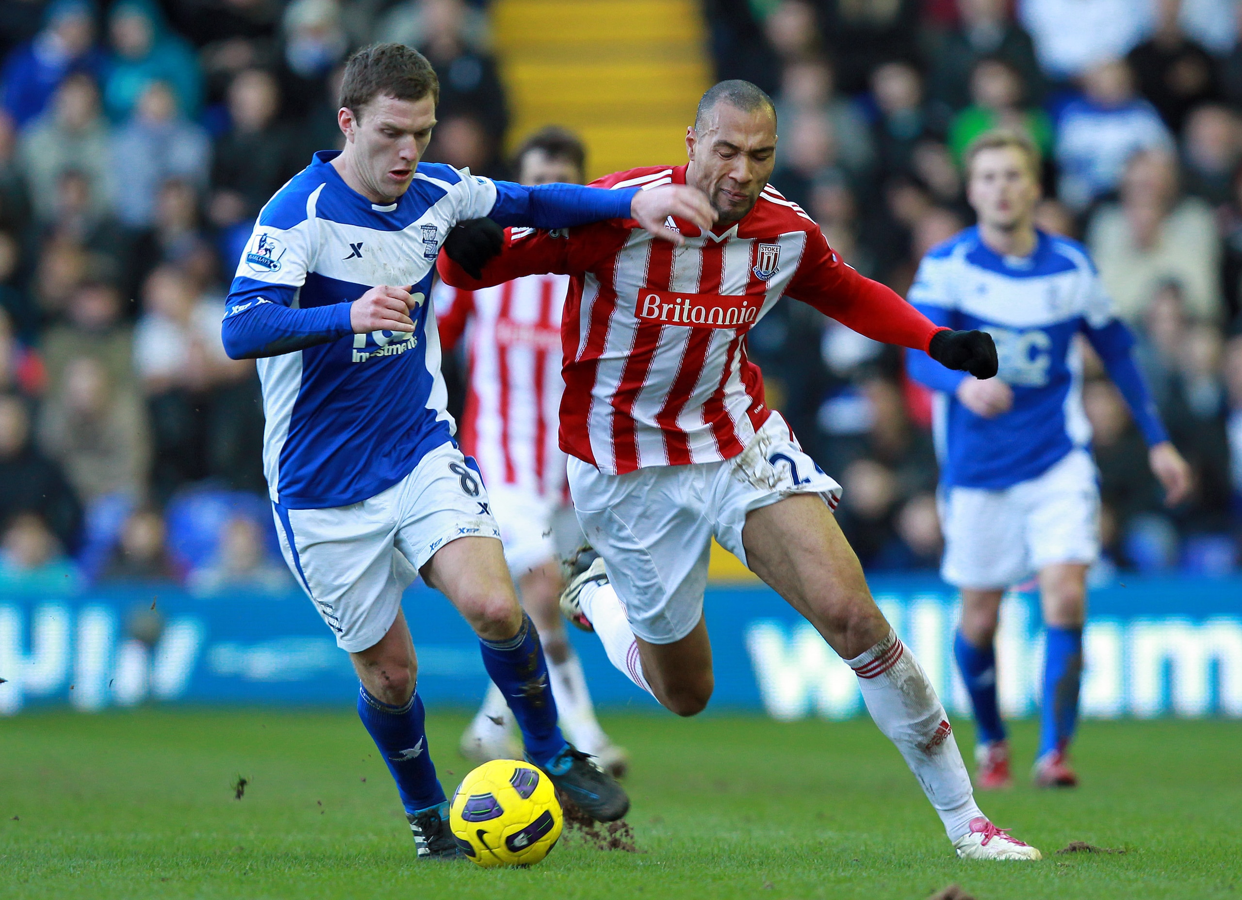 BIRMINGHAM, ENGLAND - FEBRUARY 12 :   John Carew of Stoke City holds off Craig Gardner of Birmingham City during the Barclays Premier League match between Birmingham City and Stoke City at St Andrews on February 12, 2011 in Birmingham, England.  (Photo by