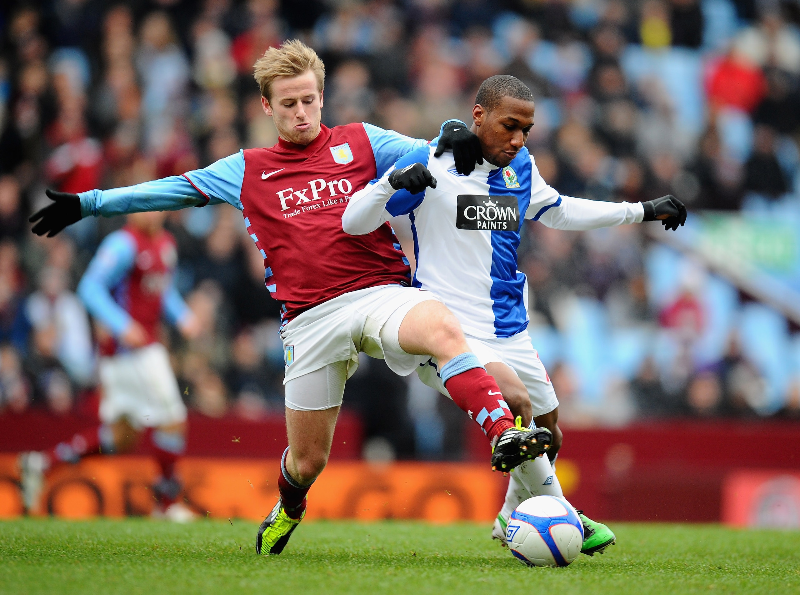 BIRMINGHAM, ENGLAND - JANUARY 29:  Barry Bannan of Aston Villa tackles Junior Hoilett of Blackburn Rovers during the FA Cup sponsored by E.On Fourth Round match between Aston Villa and Blackburn Rovers at Villa Park on January 29, 2011 in Birmingham, Engl