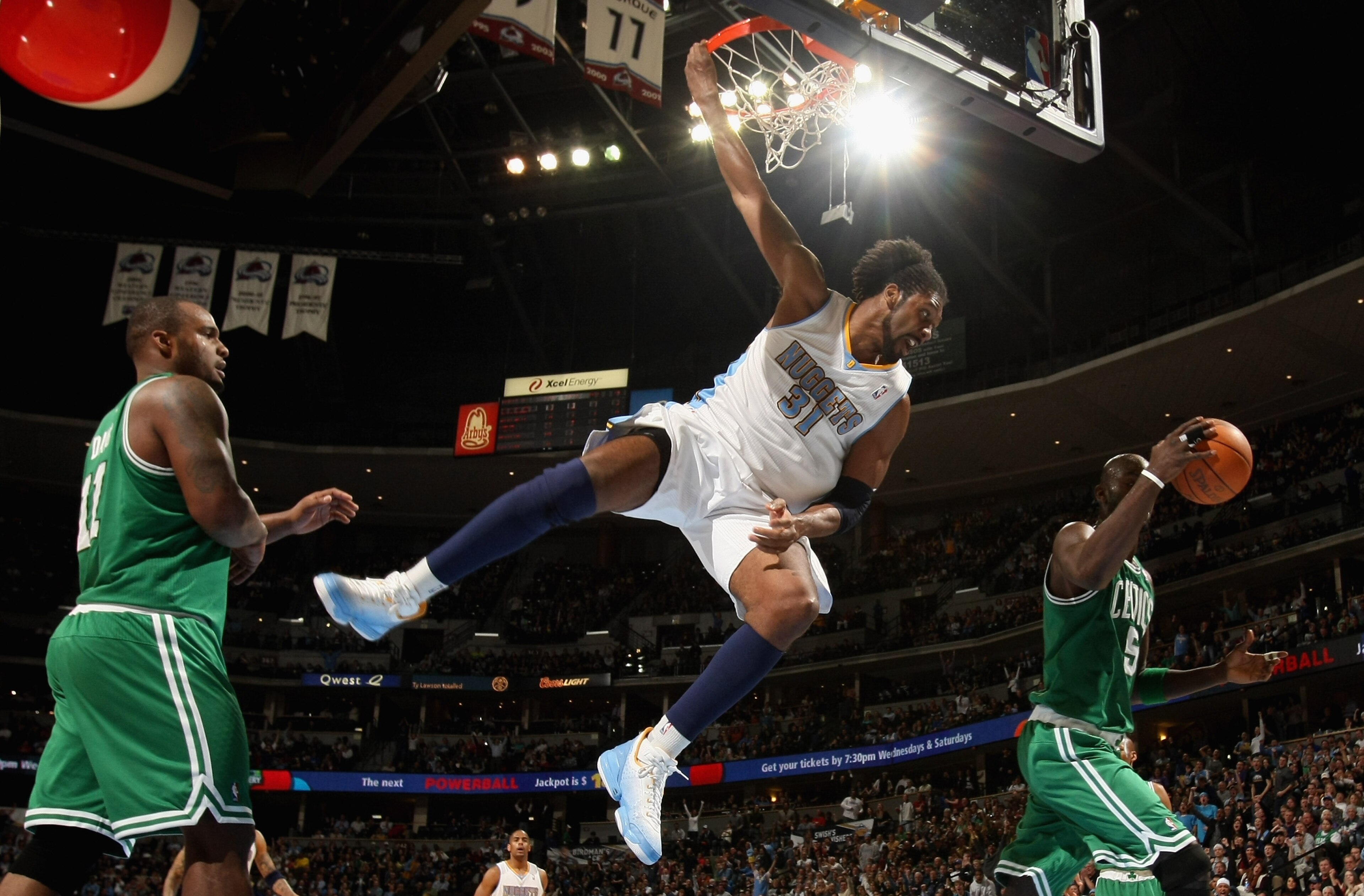 DENVER, CO - FEBRUARY 24:  Nene #31 of the Denver Nuggets is called for a technical foul as he dunks against Glen Davis #11 and Kevin Garnett #5 of the Boston Celtics during NBA action at the Pepsi Center on February 24, 2011 in Denver, Colorado. The Nugg