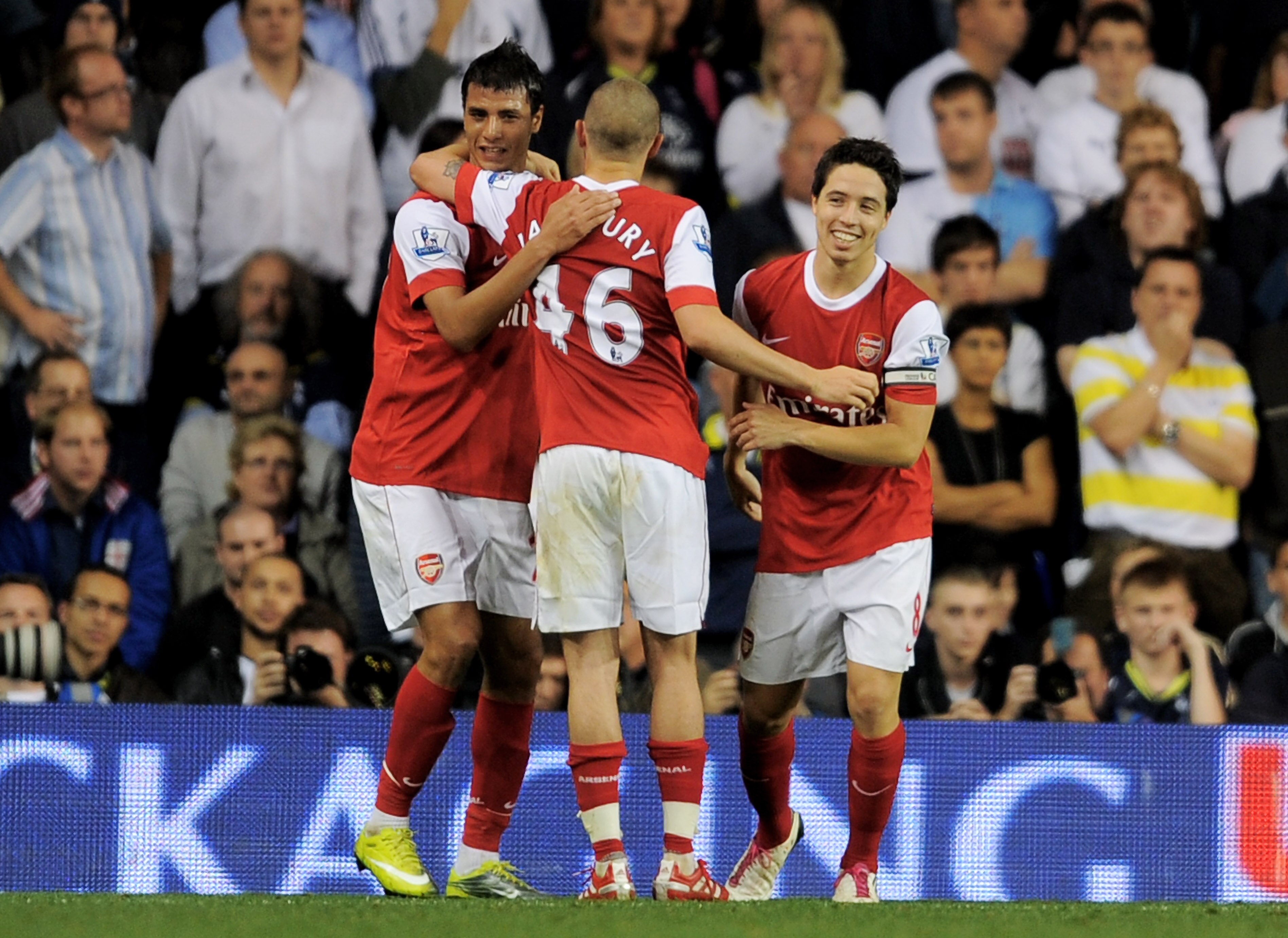 LONDON, ENGLAND - SEPTEMBER 21:  Samir Nasri (R) of Arsenal celebrates with teammates Marouane Chamakh (L) and Henri Lansbury (C) after scoring his team's third goal from the penalty spot during the Carling Cup third round match between Tottenham Hotspur