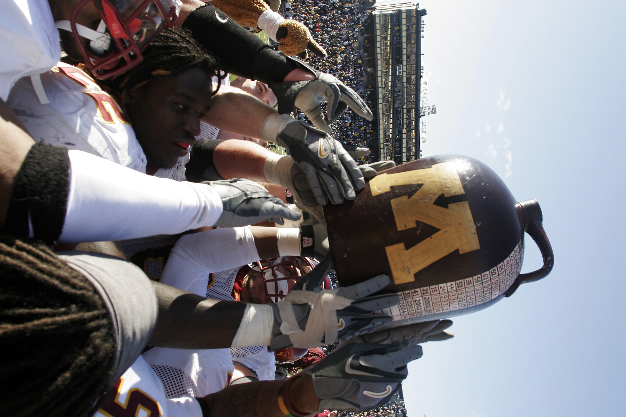 ANN ARBOR, MI - OCTOBER 8:  Minnesota players celebrate with the 'Little Brown Jug' trophy after defeating Michigan at Michigan Stadium October 8, 2005 in Ann Arbor, Michigan. Minnesota kicked a last-second field goal to win the game, 23-20.  (Photo by To
