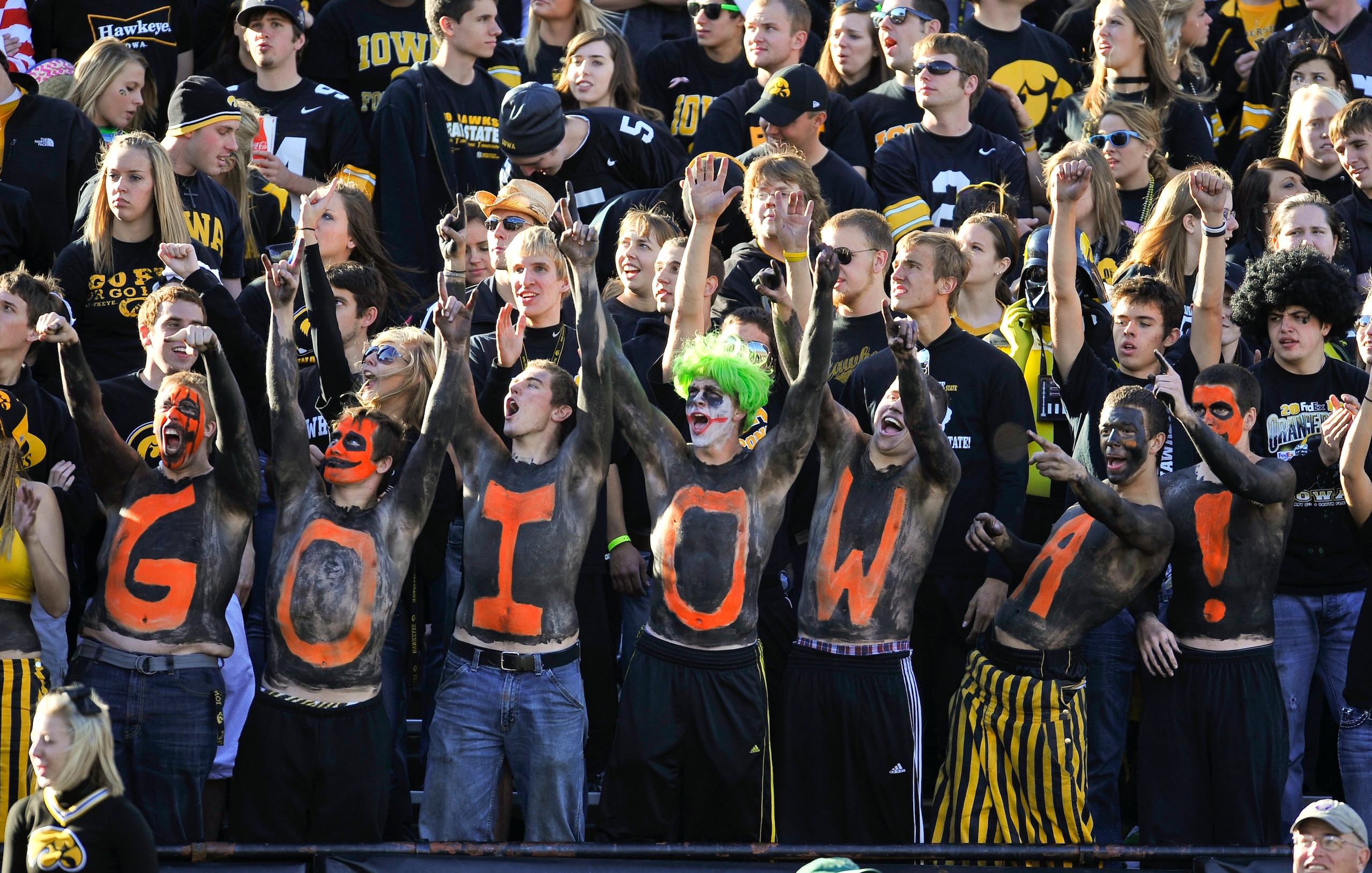 IOWA CITY, IA - OCTOBER 30: University of Iowa fans wearing Halloween paint cheer on their team during play again the Michigan State Spartans at Kinnick Stadium on October 30, 2010 in Iowa City, Iowa. Iowa won 37-6 over Michigan State. (Photo by David Pur
