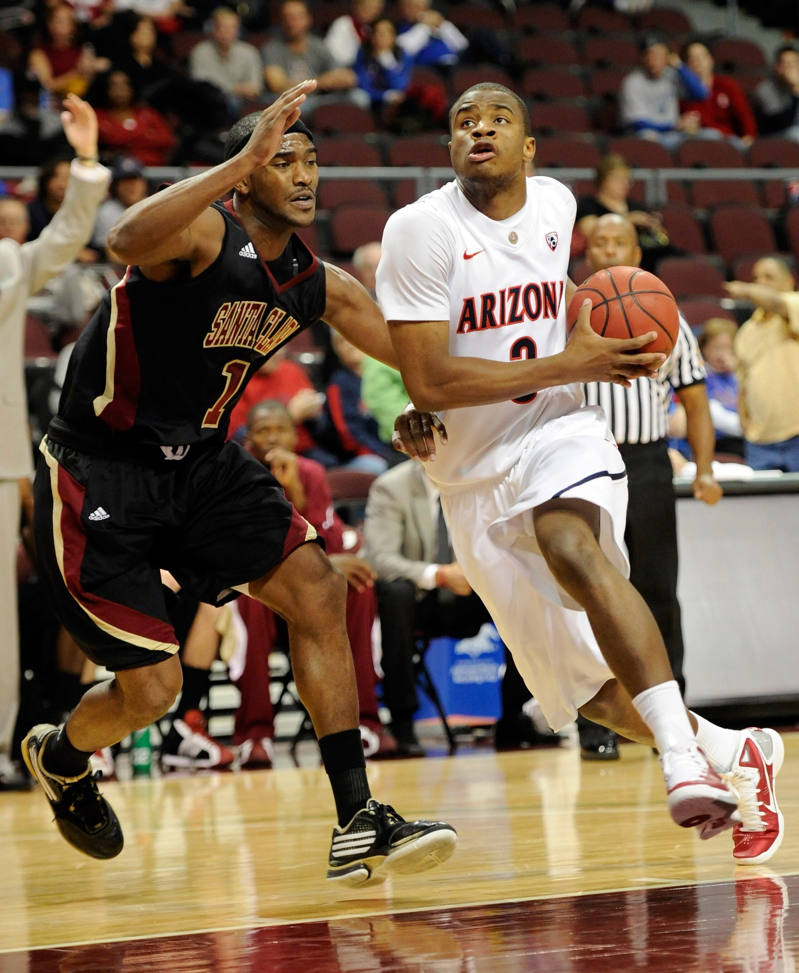 LAS VEGAS - NOVEMBER 26:  Kevin Parrom #3 of the Arizona Wildcats drives against Troy Payne #1 of the Santa Clara Broncos during the third round of the Las Vegas Invitational at The Orleans Arena November 26, 2010 in Las Vegas, Nevada. Arizona won 82-59.