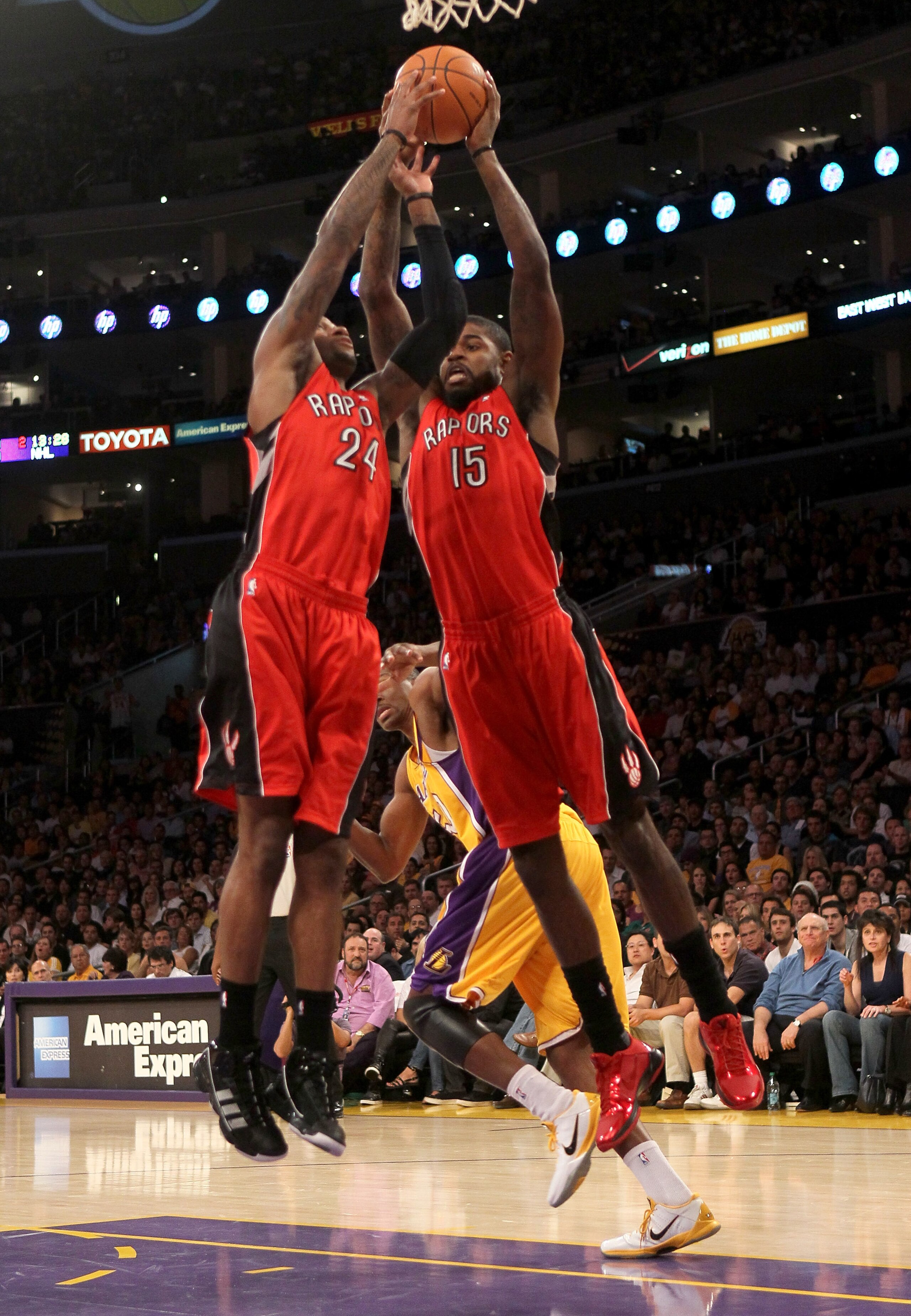 LOS ANGELES, CA - NOVEMBER 05:  Amir Johnson #15 and Sonny Weems #24 of  the Toronto Raptors go up for a rebound against the Los Angeles Lakers at Staples Center on November 5, 2010 in Los Angeles, California.  The Lakers won 108-102.   NOTE TO USER: User