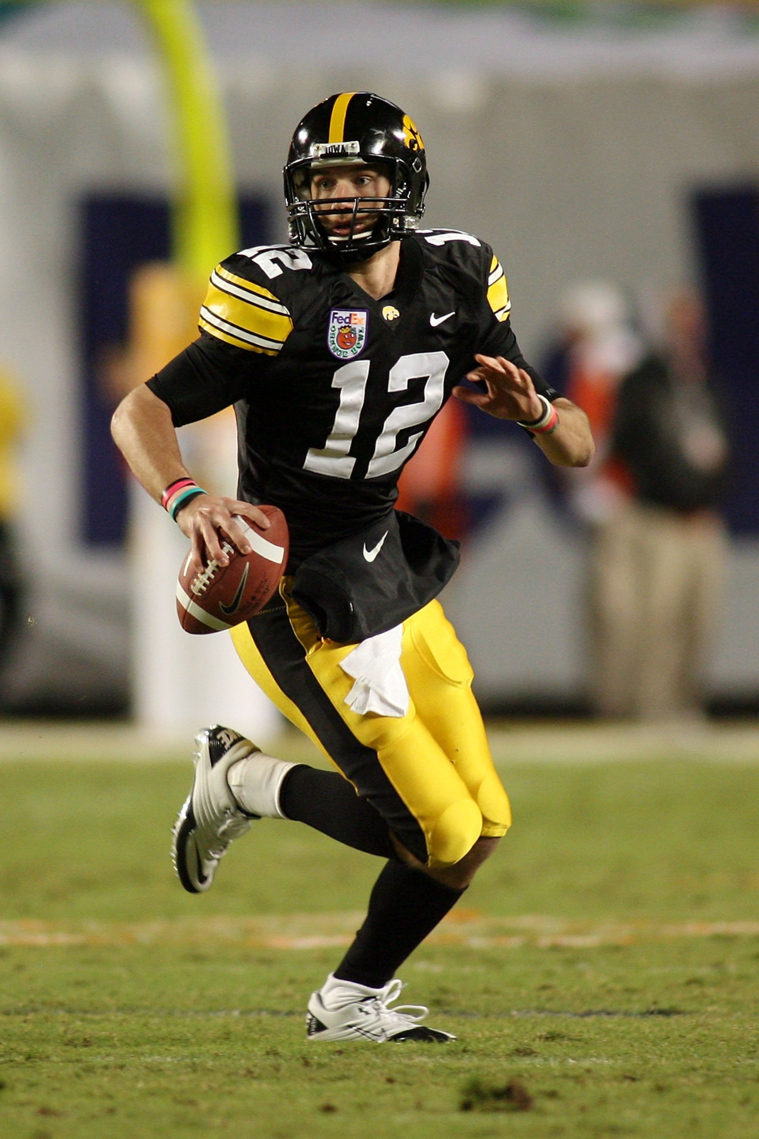 MIAMI GARDENS, FL - JANUARY 05:  Quarterback Richy Stanzi #12 of the Iowa Hawkeyes rolls out of the pocket against the Georgia Tech Yellow Jackets during the FedEx Orange Bowl at Land Shark Stadium on January 5, 2010 in Miami Gardens, Florida. Iowa won 24