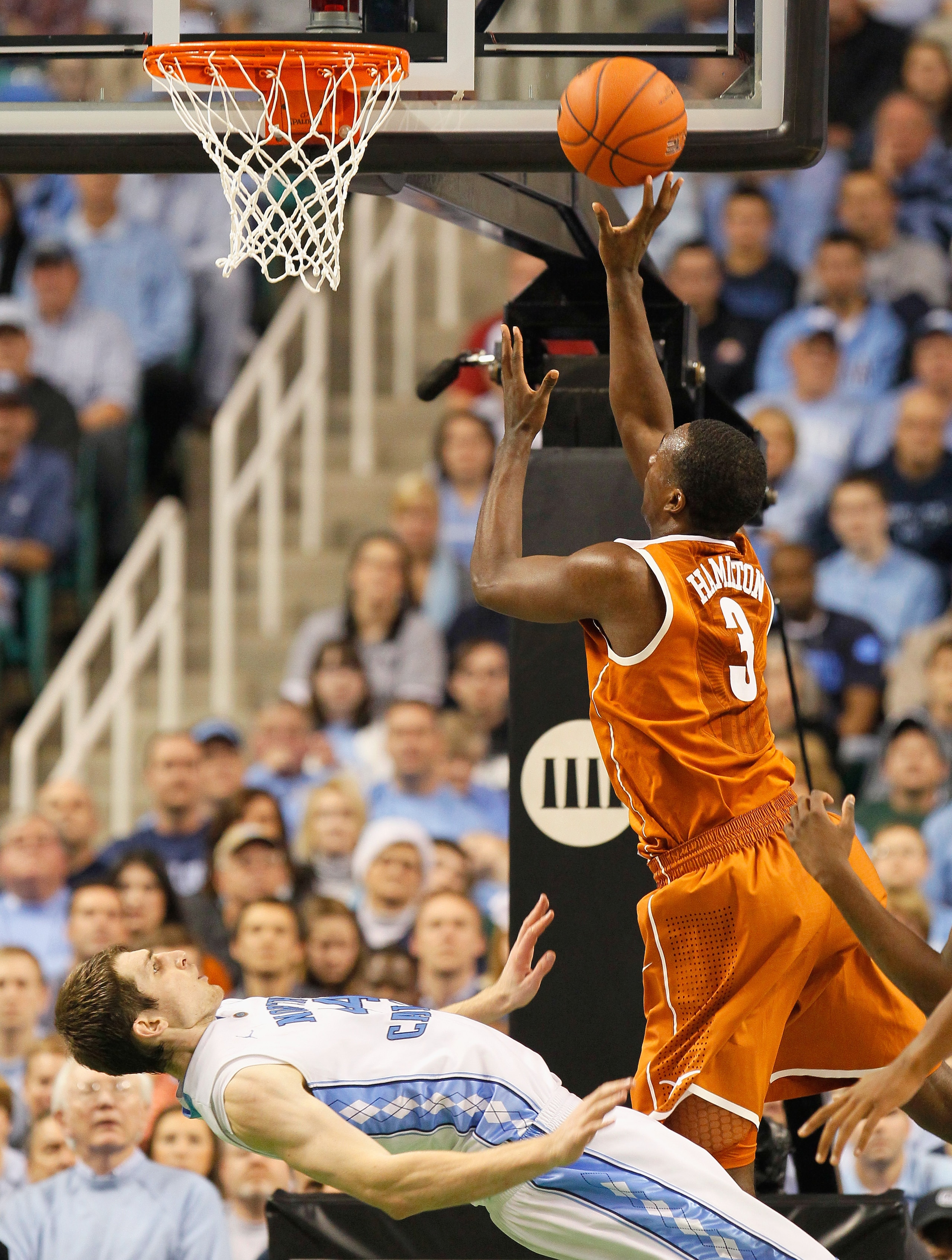 GREENSBORO, NC - DECEMBER 18:  Tyler Zeller #44 of the North Carolina Tar Heels takes a charge from Jordan Hamilton #3 of the Texas Longhorns at Greensboro Coliseum on December 18, 2010 in Greensboro, North Carolina.  (Photo by Kevin C. Cox/Getty Images)
