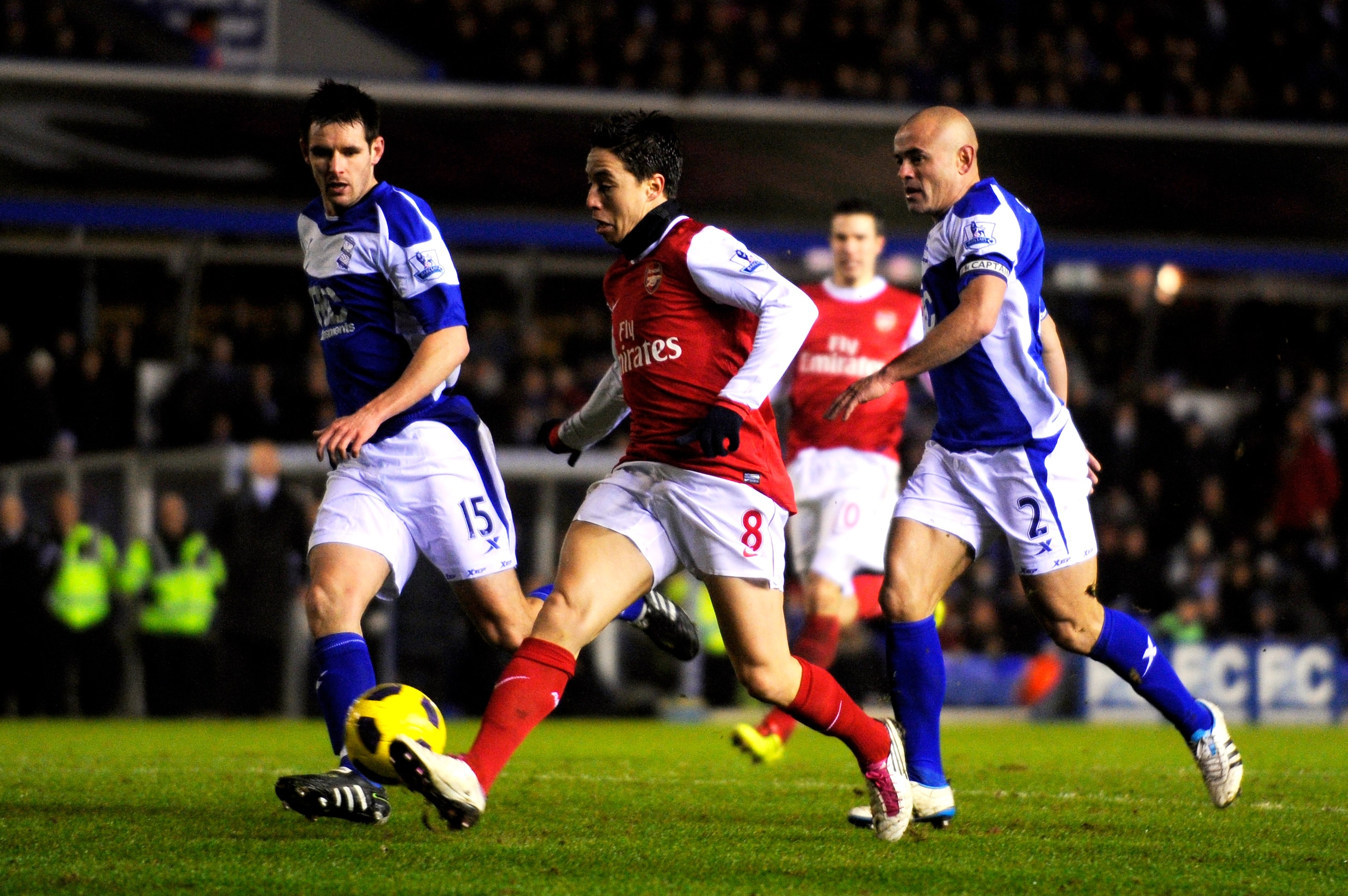 BIRMINGHAM, ENGLAND - JANUARY 01:  Samir Nasri of Arsenal takes a shot on goal as Scott Dann (L) and Stephen Carr (R) of Birmingham close in during the Barclays Premier Leaue match between Birmingham City and Arsenal at St. Andrews on January 1, 2011 in B