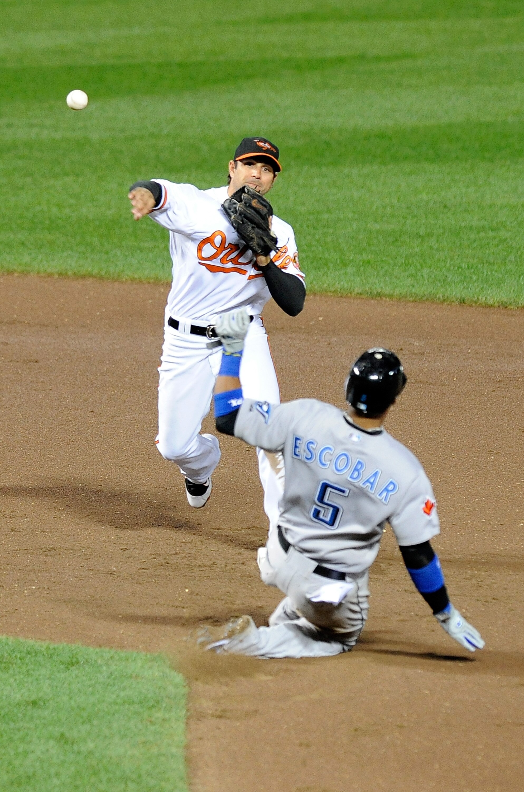 BALTIMORE - SEPTEMBER 13:  Brian Roberts #1 of the Baltimore Orioles forces out Yunel Escobar #5 of the Toronto Blue Jays to start a double play at Camden Yards on September 13, 2010 in Baltimore, Maryland.  (Photo by Greg Fiume/Getty Images)