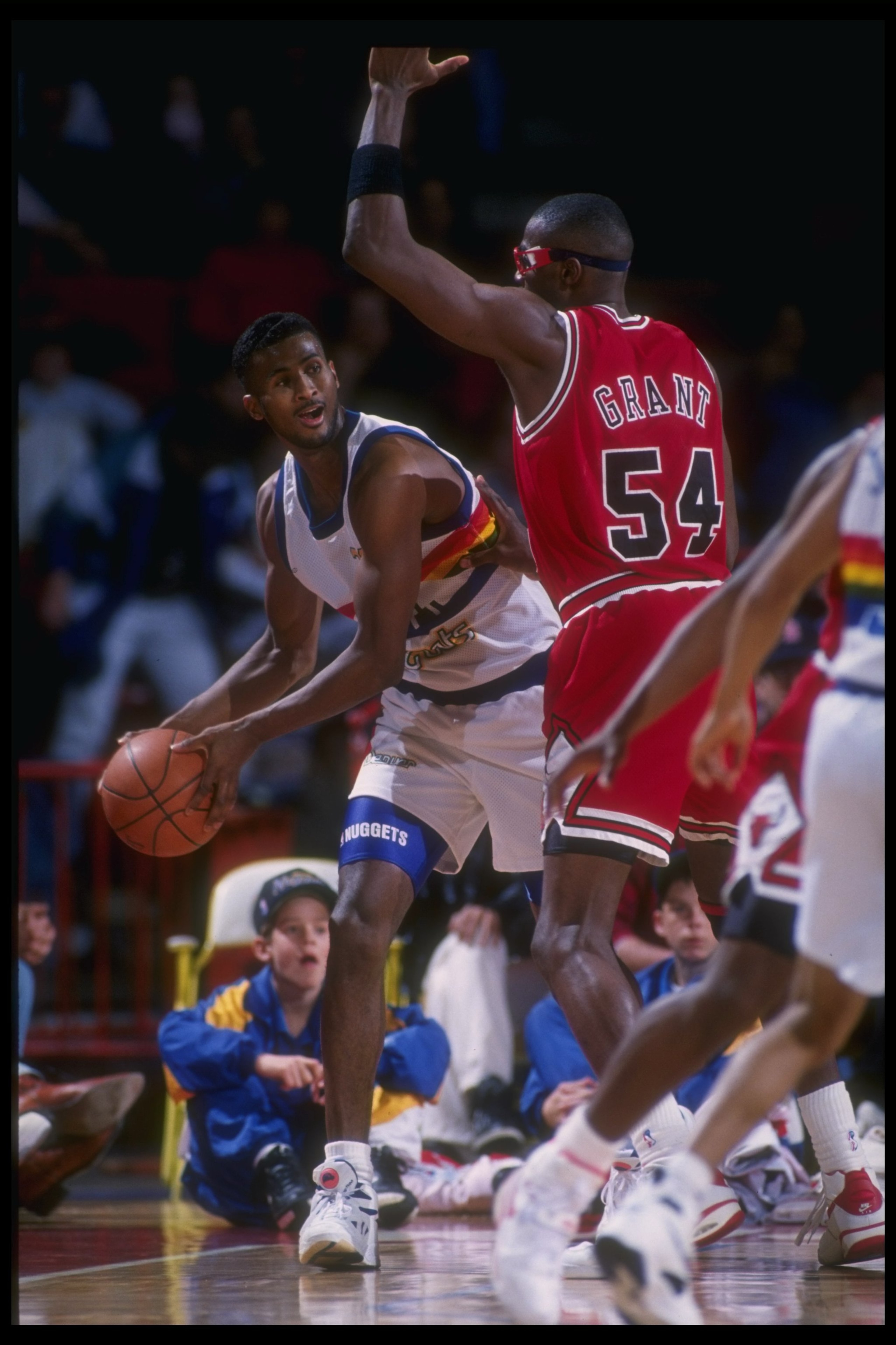 1992-1993:  Forward Marcus Liberty of the Denver Nuggets looks to pass the ball around forward Horace Grant of the Chicago Bulls during a game against the Chicago Bulls at McNichols Arena in Denver, Colorado. Mandatory Credit: Tim DeFrisco  /Allsport Mand