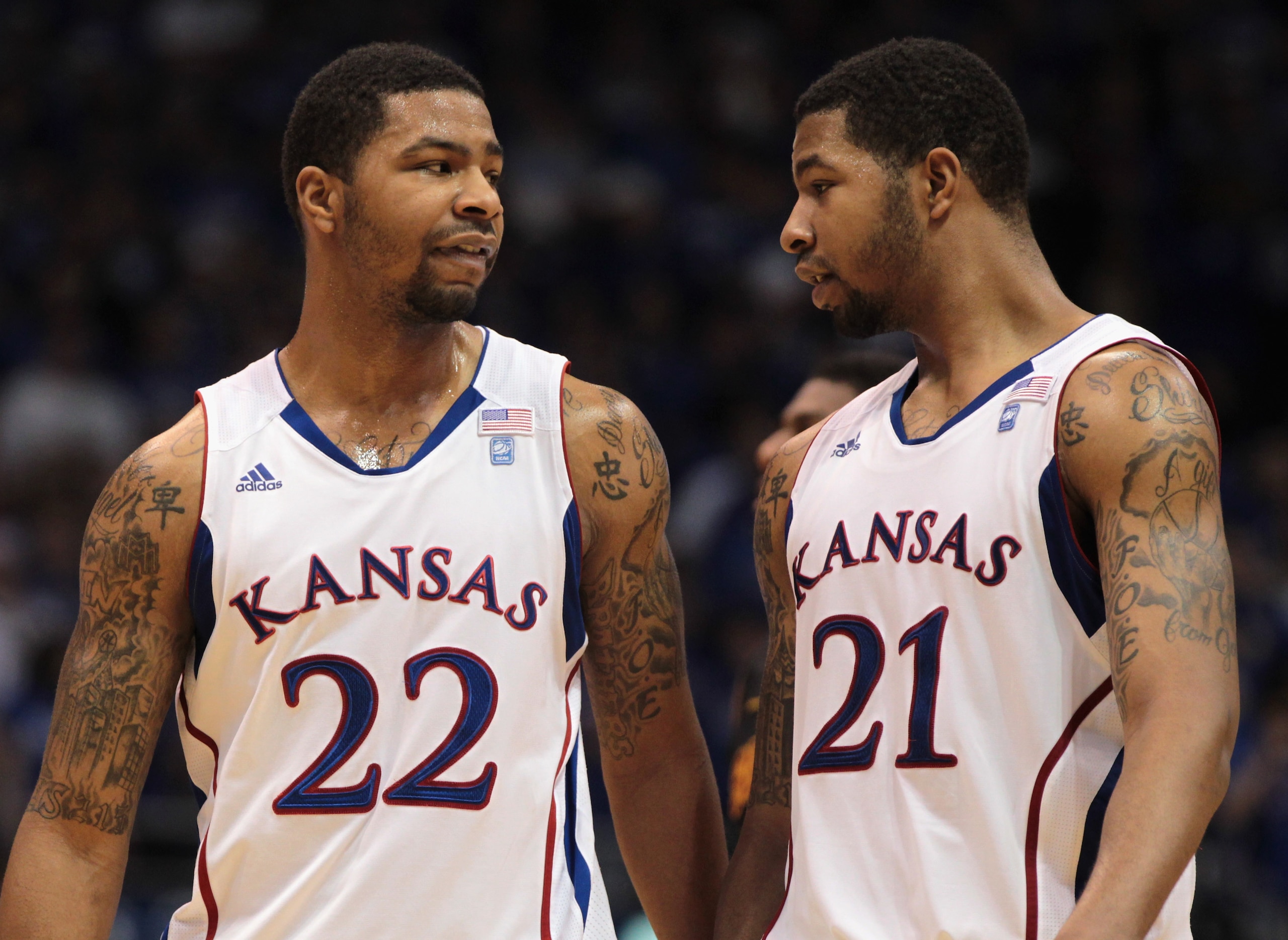 LAWRENCE, KS - DECEMBER 18:  Marcus Morris #22 and Markieff Morris #21 of the Kansas Jayhawks talk during the game against the USC Trojans on December 18, 2010 at Allen Fieldhouse in Lawrence, Kansas.  (Photo by Jamie Squire/Getty Images)