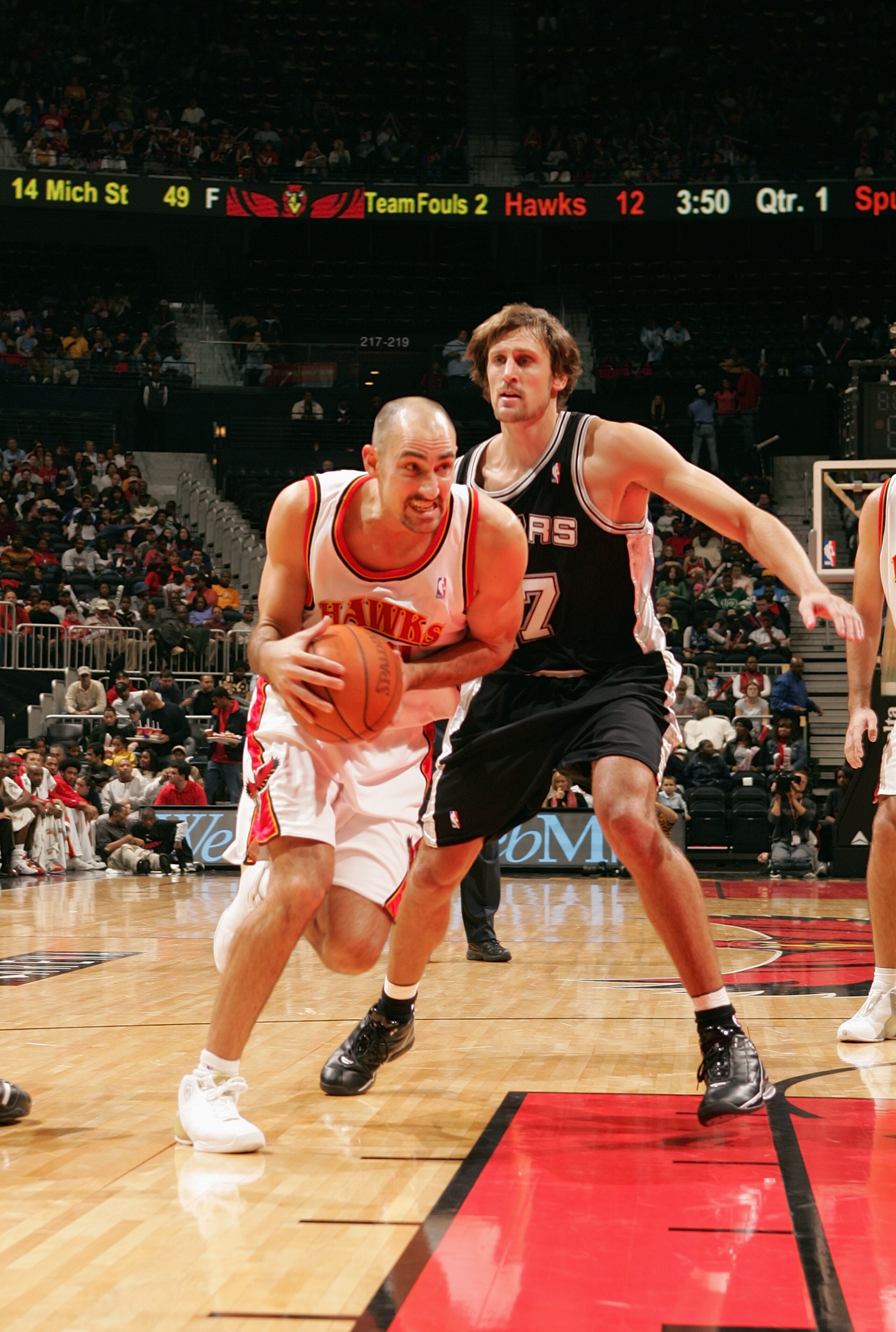 ATLANTA - NOVEMBER 13:  Jon Barry #20 of the Atlanta Hawks drives around Brent Barry #17 of the San Antonio Spurs during the game on November 13, 2004 at Philips Arena in Atlanta, Georgia.  The Spurs won 103-88.  NOTE TO USER: User expressly acknowledges