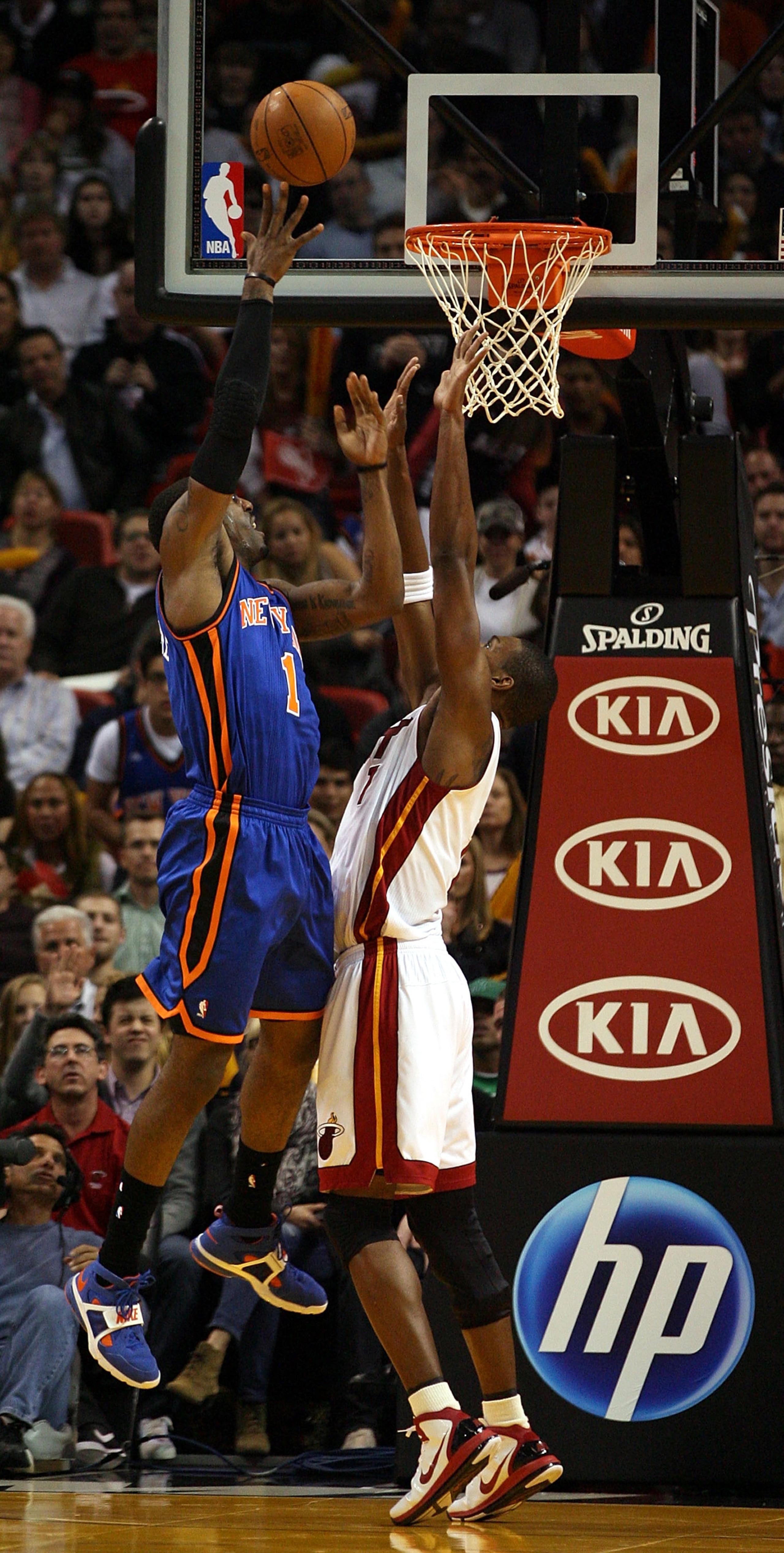 MIAMI - DECEMBER 28:  Amar'e Stoudemire #1 of the New York Knicks shoots over Chris Bosh #1 of the Miami Heat at American Airlines Arena on December 28, 2010 in Miami, Florida. the Heat defeated the Knicks 106-98.  (Photo by Marc Serota/Getty Images)