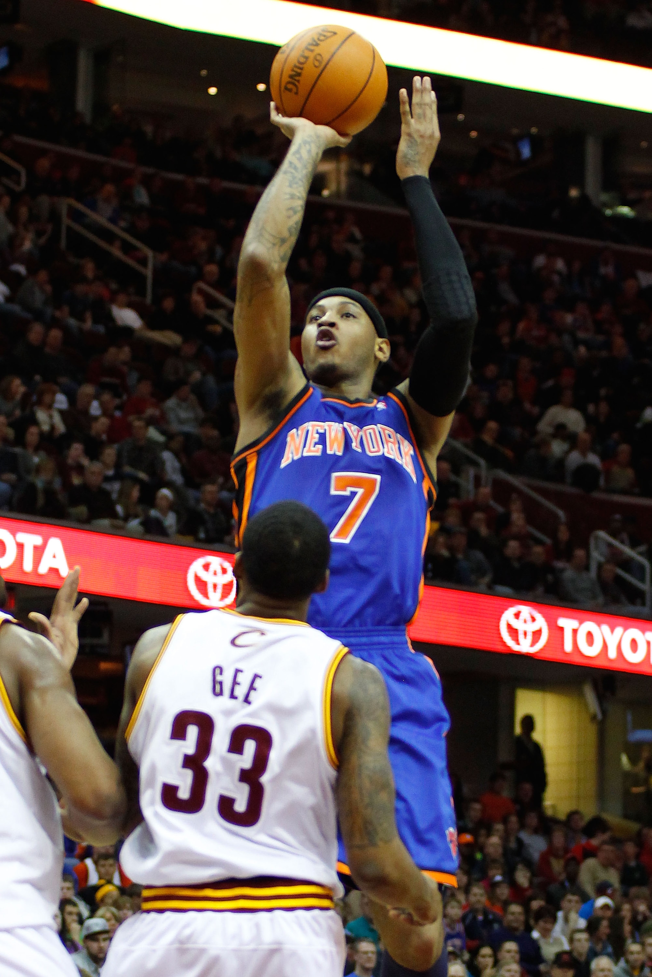 CLEVELAND - FEBRUARY 25:  Carmelo Anthony #7 of the New York Knicks attempts a shot over Alonzo Gee #33 of the Cleveland Cavaliers during the game on February 25, 2011 at Quicken Loans Arena in Cleveland, Ohio.  NOTE TO USER: User expressly acknowledges a