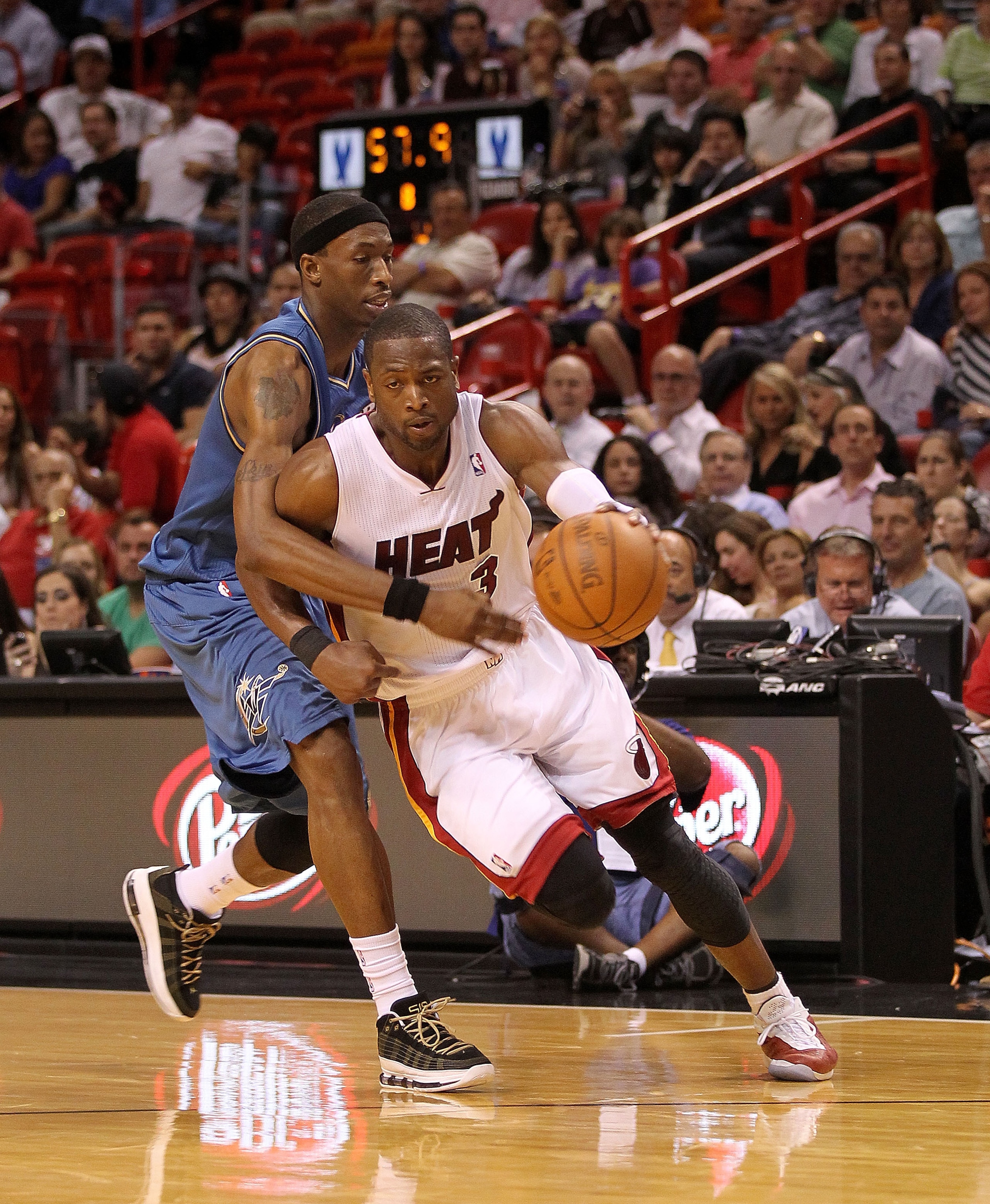 MIAMI, FL - FEBRUARY 25:  Dwyane Wade #3 of the Miami Heat is fouled by Josh Howard #5 of the Washington Wizards during a game at American Airlines Arena on February 25, 2011 in Miami, Florida. NOTE TO USER: User expressly acknowledges and agrees that, by
