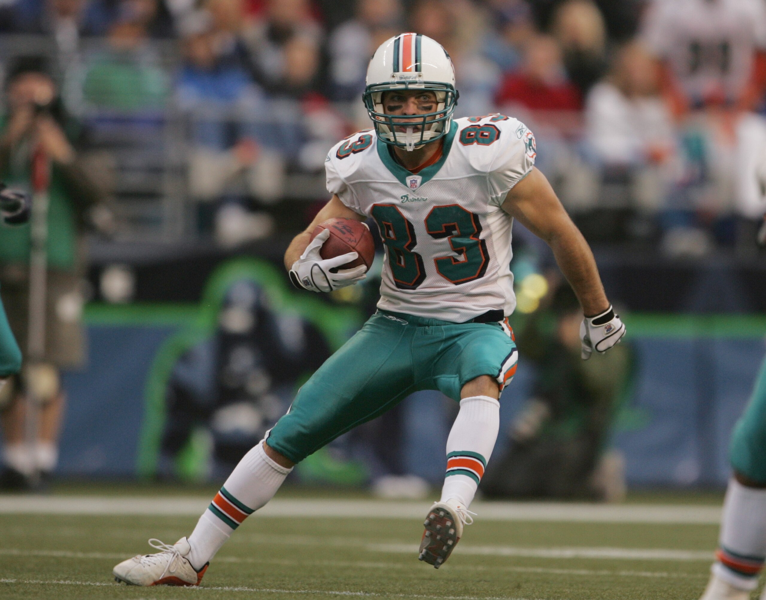 SEATTLE, WA - NOVEMBER 21:  Wide receiver Wesley Welker #83 of the Miami Dolphins runs upfield against the Seattle Seahawks during the game at Qwest Field on November 21, 2004 in Seattle, Washington. The Seahawks defeated the Dolphins 24-17. (Photo by Jef