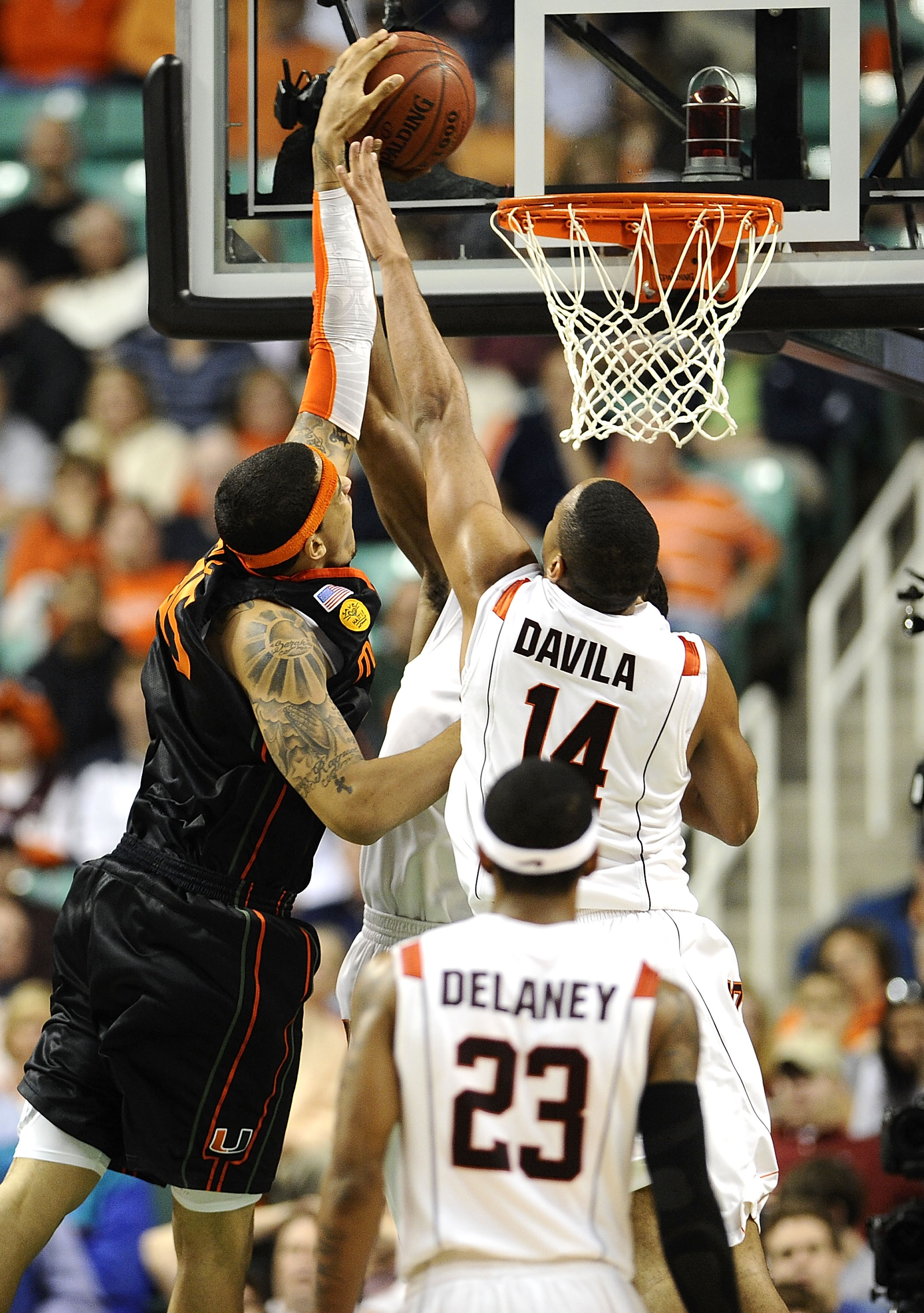 GREENSBORO, NC - MARCH 12:  Victor Davila #14 of the Virginia Tech Hokies is blocked by Julian Gamble #45 of the University of Miami Hurricanes in their quarterfinal game in the 2010 ACC Men's Basketball Tournament at the Greensboro Coliseum on March 12,