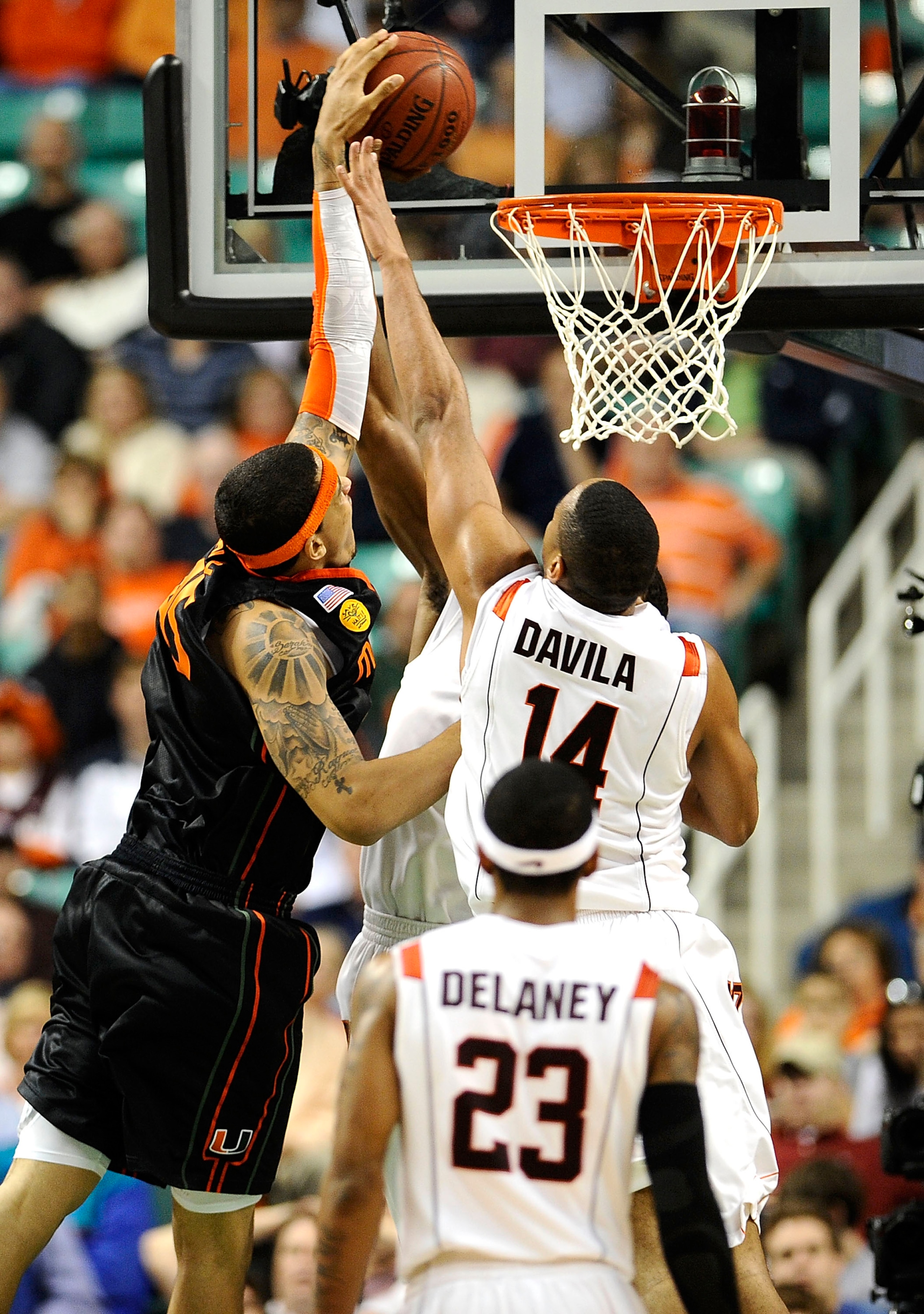 GREENSBORO, NC - MARCH 12:  Victor Davila #14 of the Virginia Tech Hokies is blocked by Julian Gamble #45 of the University of Miami Hurricanes in their quarterfinal game in the 2010 ACC Men's Basketball Tournament at the Greensboro Coliseum on March 12,