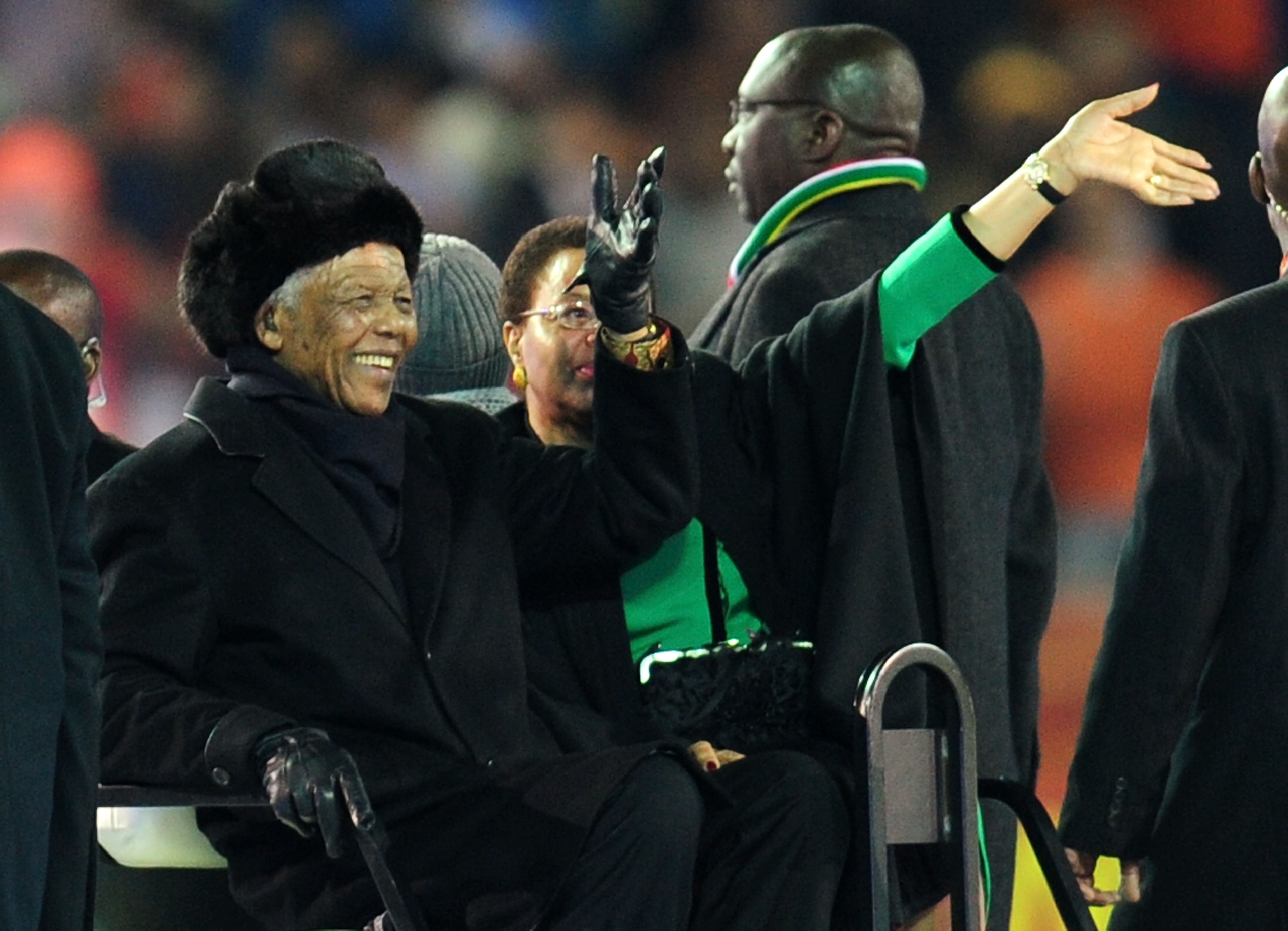 JOHANNESBURG, SOUTH AFRICA - JULY 11:  Former South Africa President Nelson Mandela and wife Graca Machel wave to the crowds prior to the 2010 FIFA World Cup South Africa Final match between Netherlands and Spain at Soccer City Stadium on July 11, 2010 in