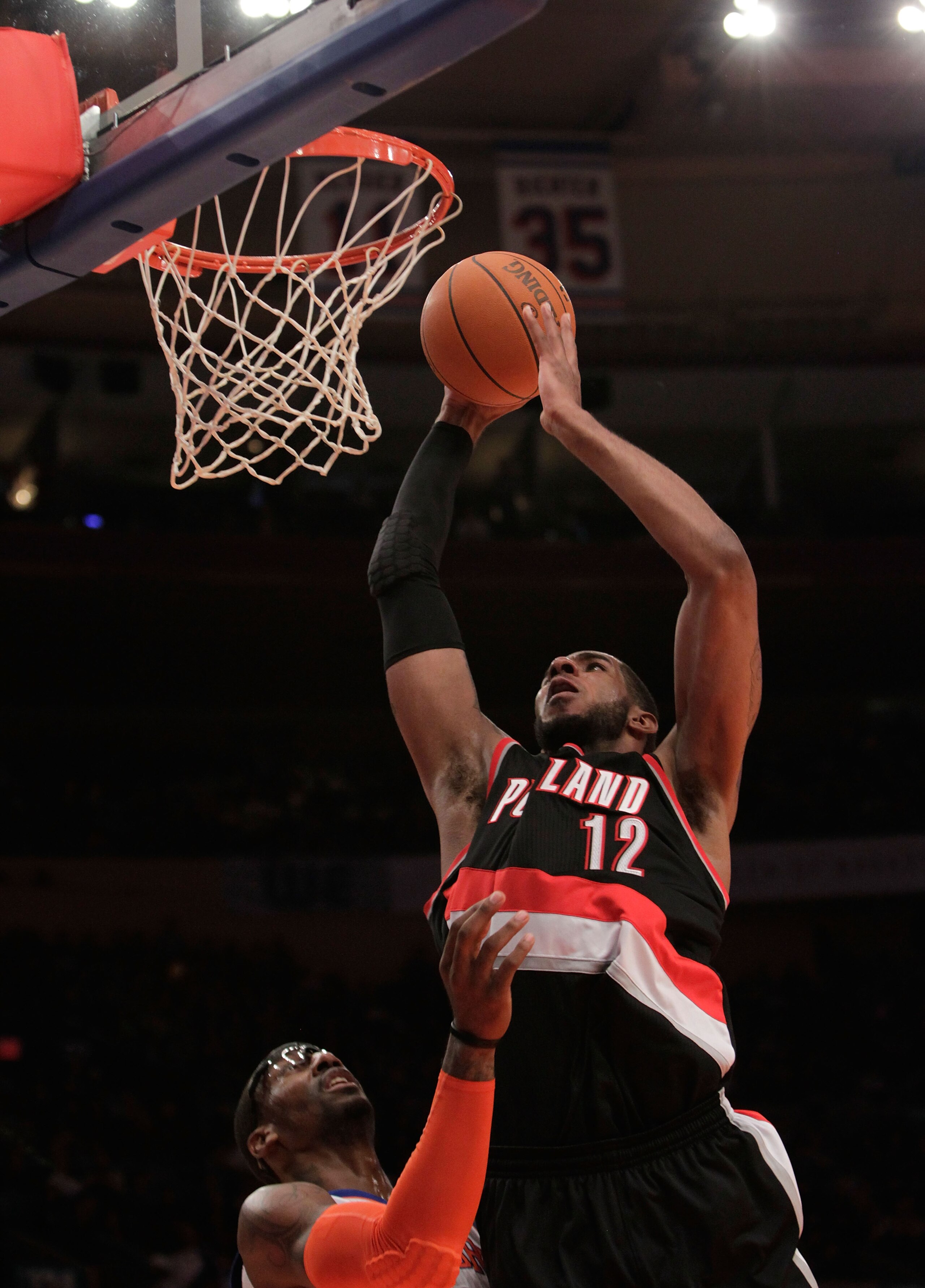 NEW YORK - OCTOBER 30:  LaMarcus Aldridge #12 of the Portland Trail Blazers dunks over Amar'e Stoudemire #1 of the New York Knicks at Madison Square Garden on October 30, 2010 in New York City. NOTE TO USER: User expressly acknowledges and agrees that, by