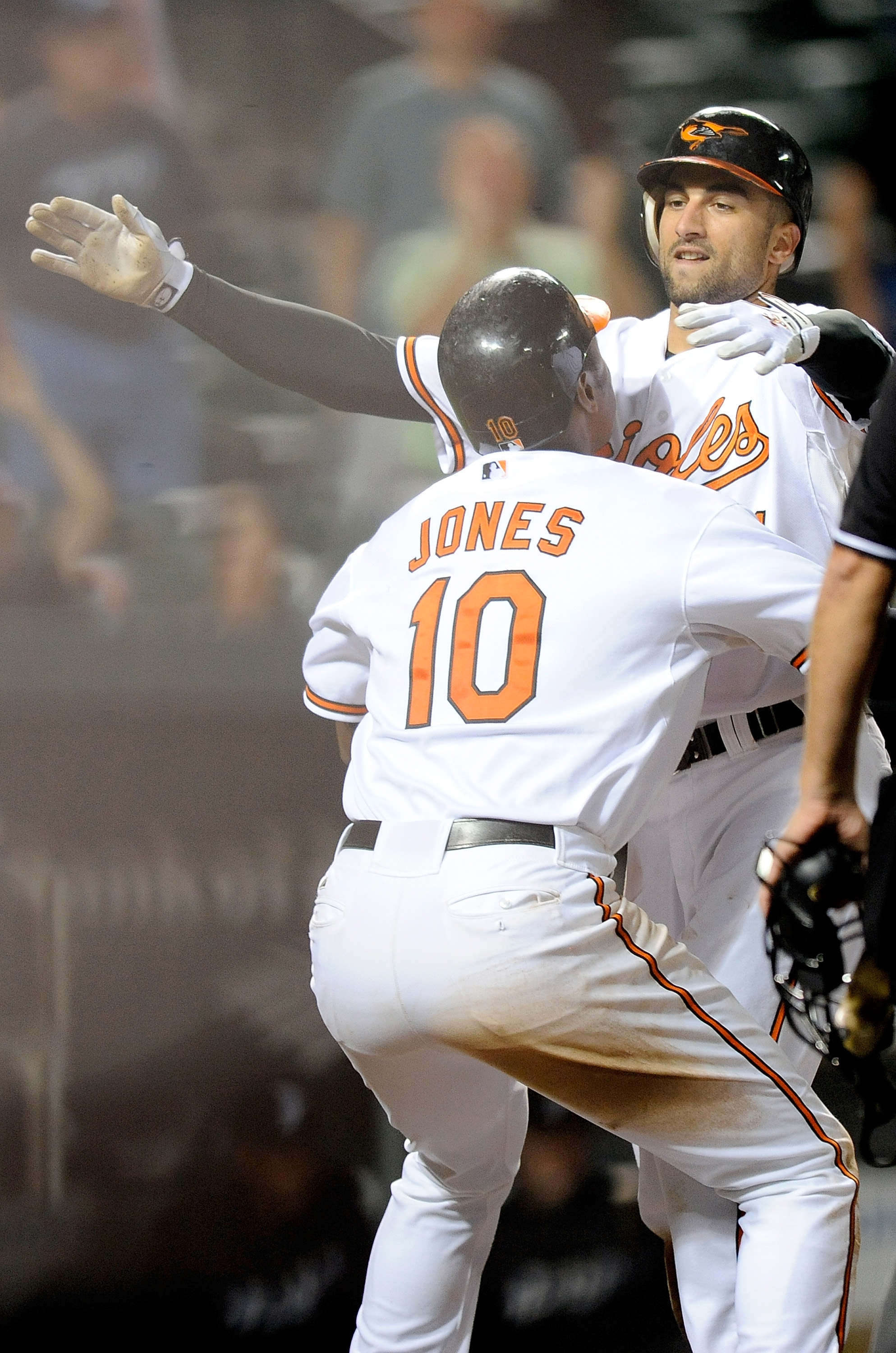 BALTIMORE - SEPTEMBER 13:  Nick Markakis #21 of the Baltimore Orioles celebrates with Adam Jones #10 after scoring the winning run in the eleventh inning against the Toronto Blue Jays at Camden Yards on September 13, 2010 in Baltimore, Maryland. The Oriol