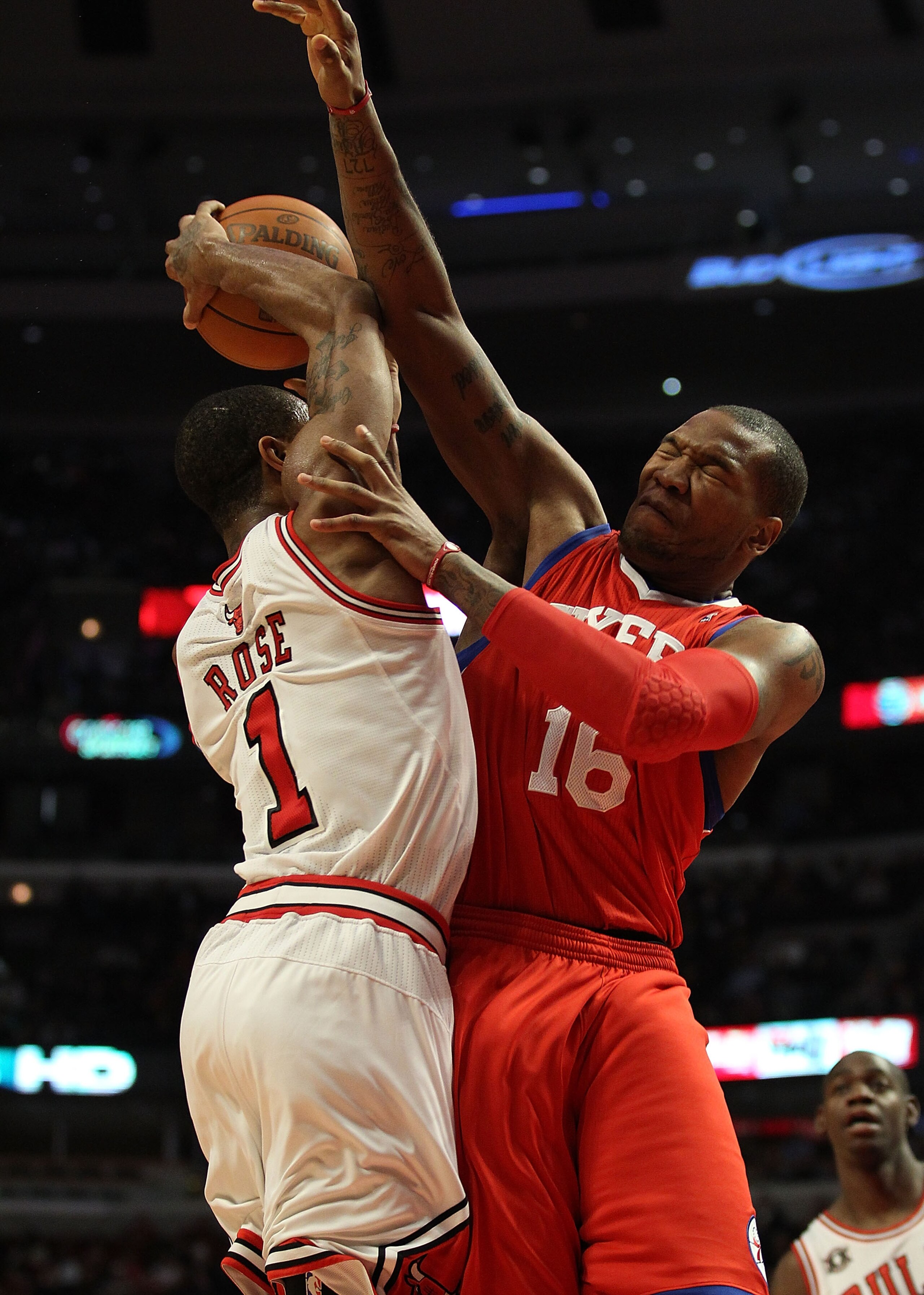 CHICAGO, IL - DECEMBER 21: Derrick Rose #1 of the Chicago Bulls is fouled while shooting by Marreese Speights #16 of the Philadelphia 76ers at the United Center on December 21, 2010 in Chicago, Illinois. The Bulls defeated the 76ers 121-76. NOTE TO USER: CHICAGO, IL - DECEMBER 21: Derrick Rose #1 of the Chicago Bulls is fouled while shooting by Marreese Speights #16 of the Philadelphia 76ers at the United Center on December 21, 2010 in Chicago, Illinois. The Bulls defeated the 76ers 121-76. NOTE TO USER: