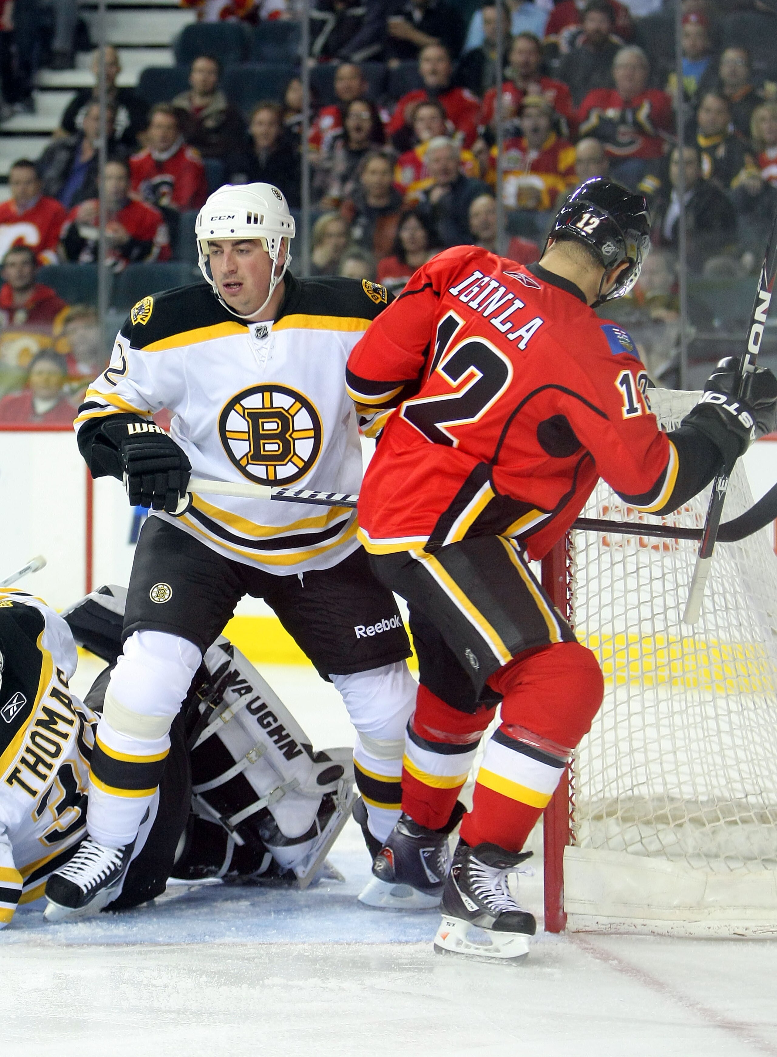 CALGARY,CANADA - FEBRUARY 22:  Tomas Kaberle #12 of the Boston Bruins battles with Jarome Iginla #12 of the Calgary Flames during their NHL game at Scotiabank Saddledome, February 22,2011 in Calgary, Alberta, Canada.(Photo By Dave Sandford/Getty Images)